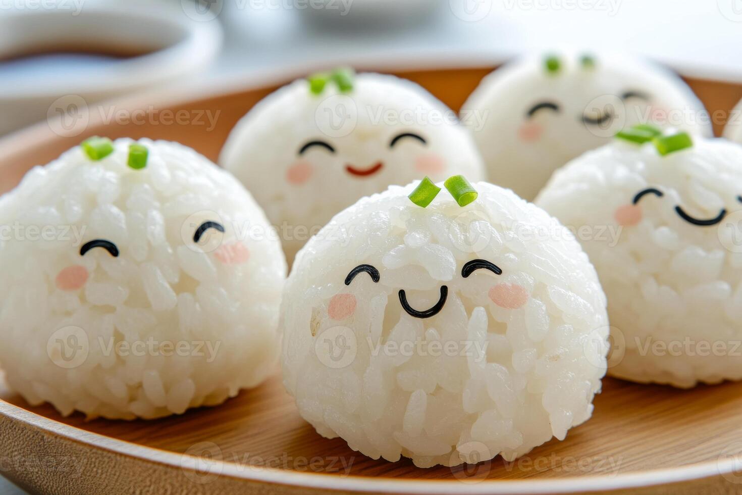 Cute rice balls with cheerful faces on a minimalist plate in a Japanese style setting photo
