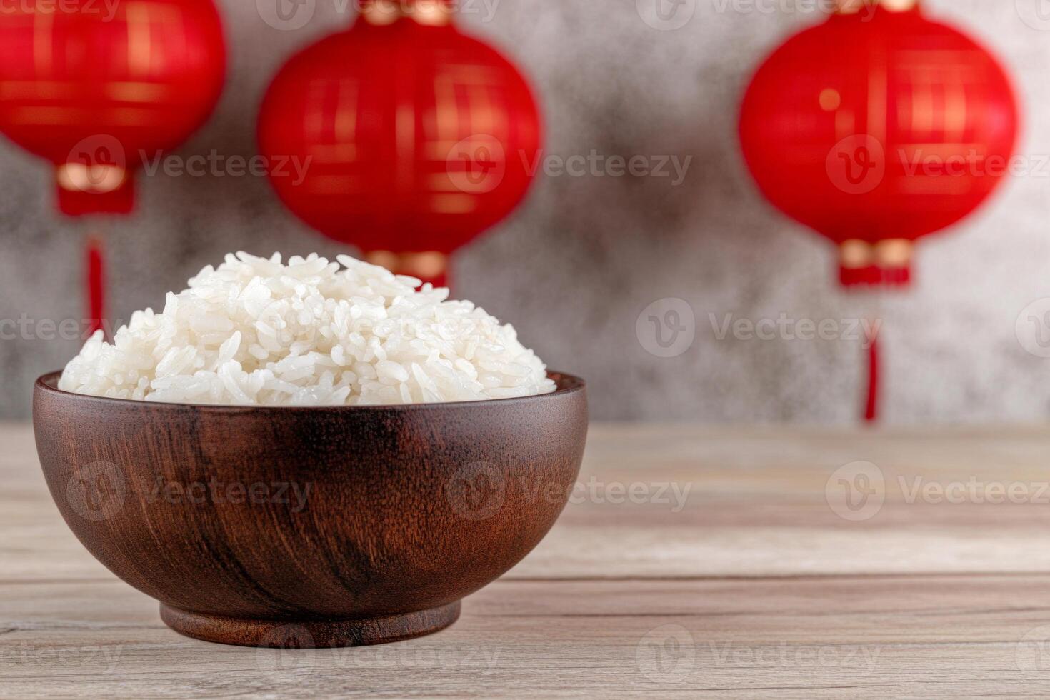 A wooden bowl filled with white rice surrounded by red lanterns in a modern oriental decor setting photo