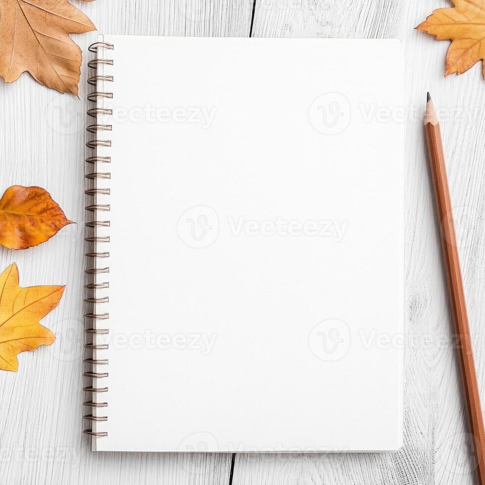 Warm-toned sketchbook filled with botanical artwork, scattered leaves, and vintage watercolor accents photo
