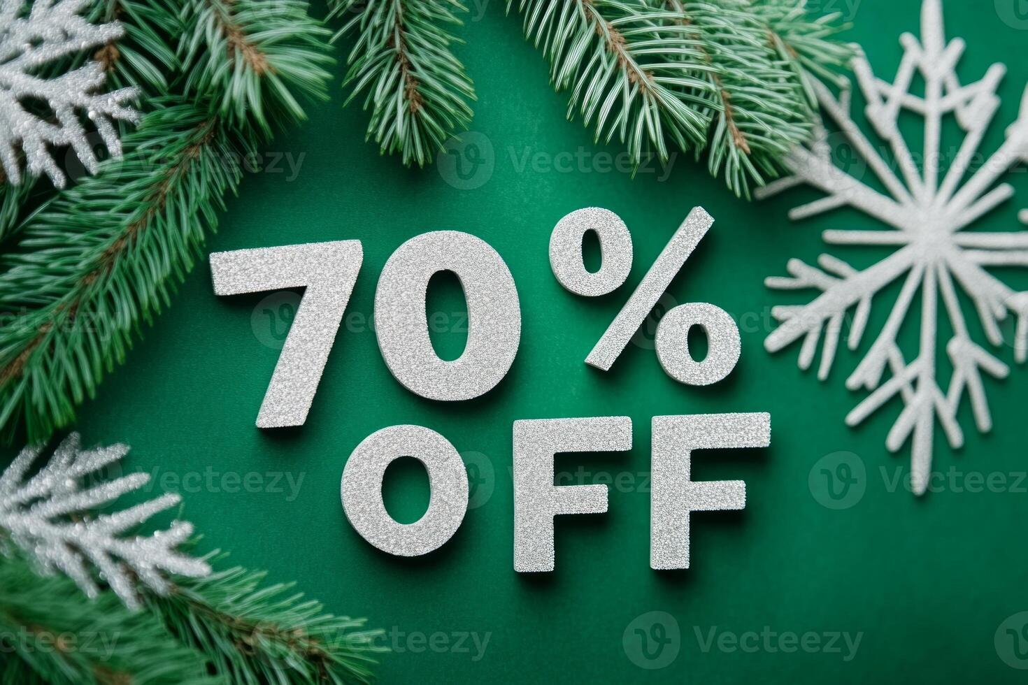 Elegant holiday sale announcement featuring 70 percent off with snowflakes and pine branches on deep green background photo