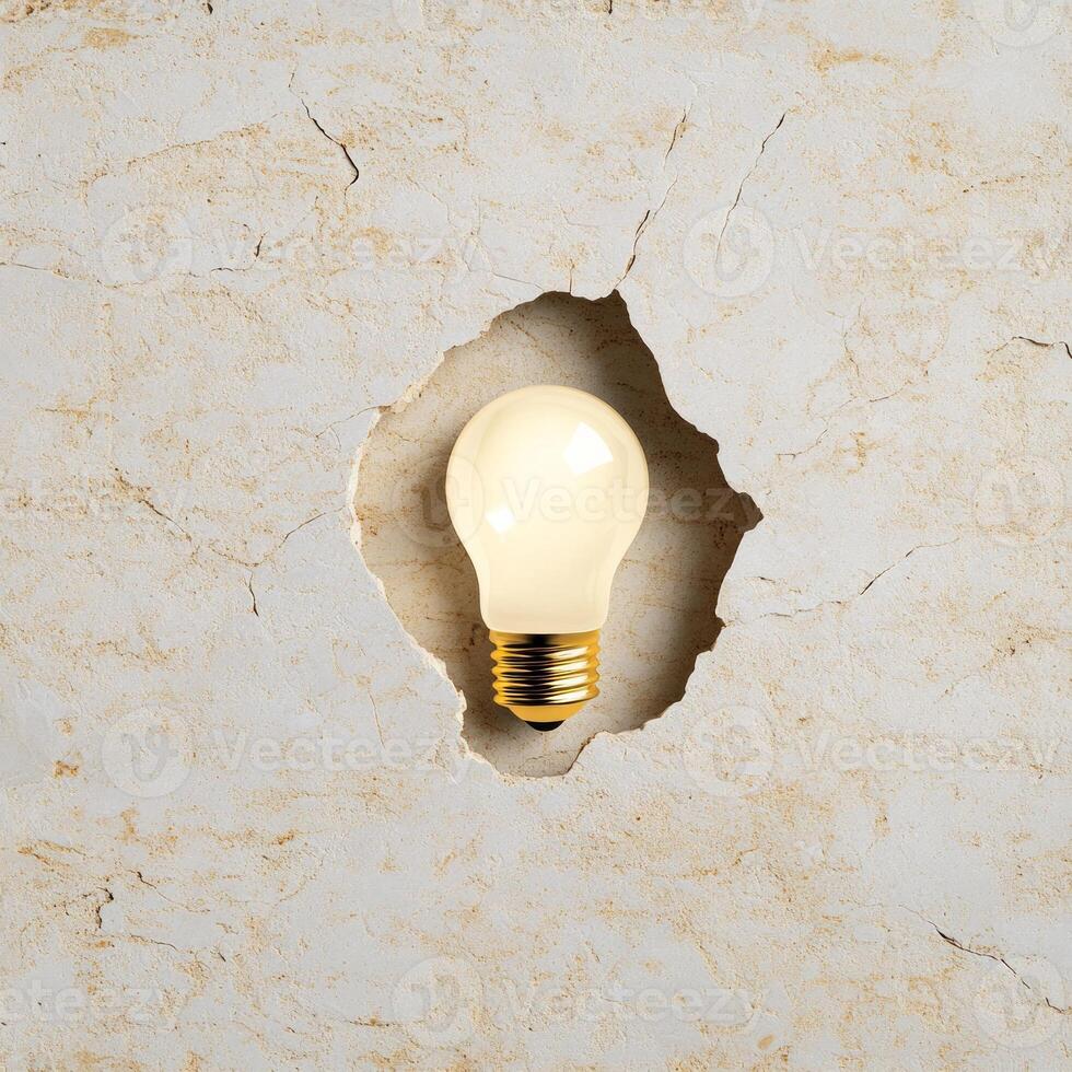 A light bulb embedded in a textured stone surface illustrating creative ideas emerging from calm reflection photo