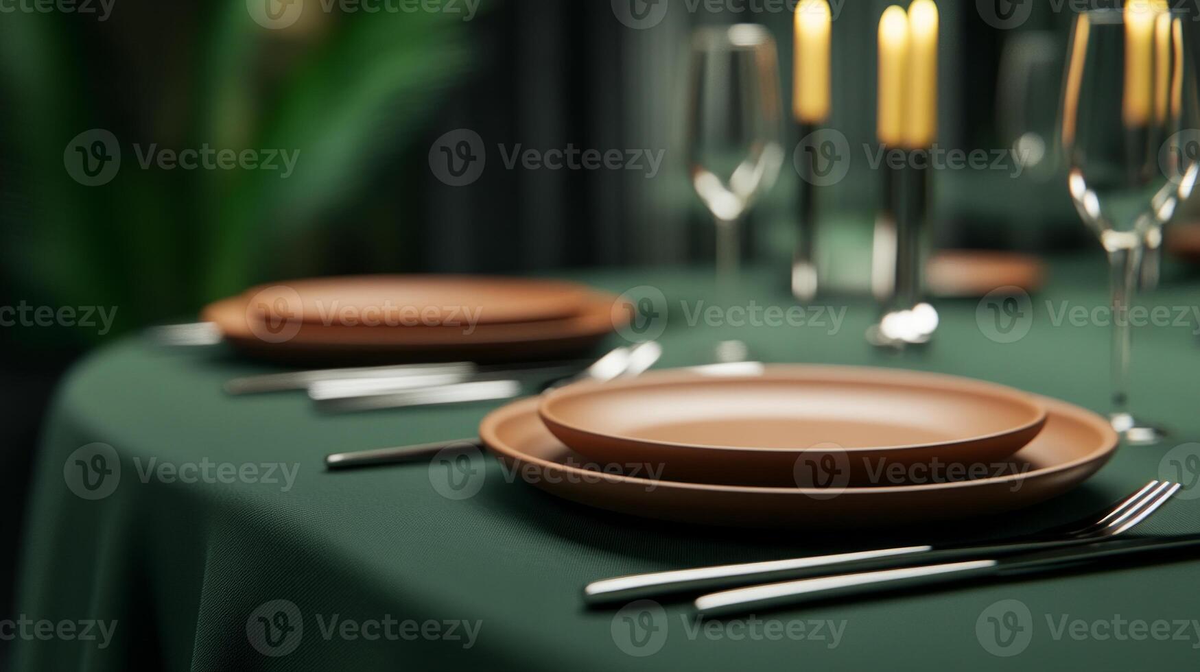 Elegant dining table set with dark green tablecloth and terracotta plates, perfect for an evening gathering photo