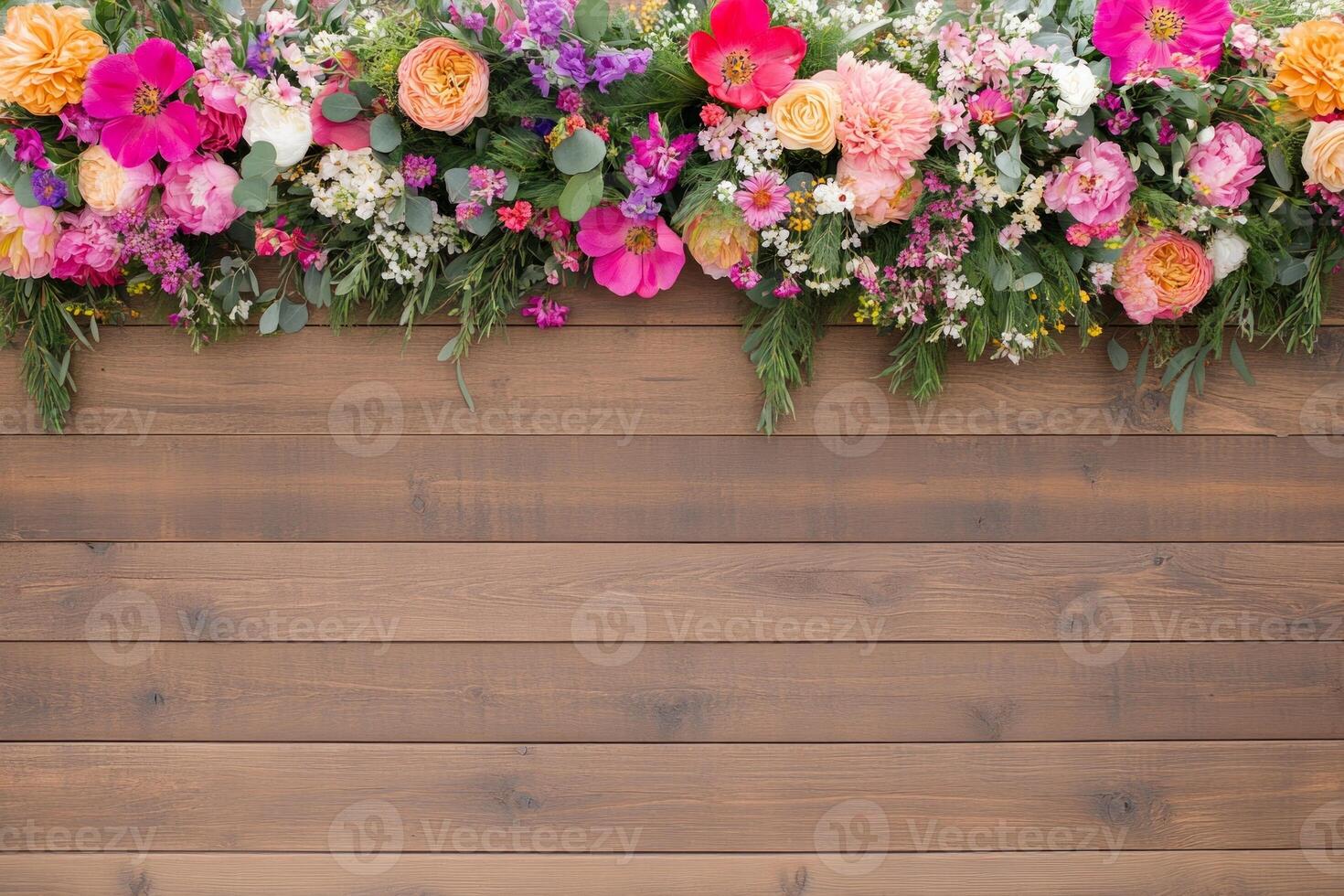 Decorative boho garden setting with a colorful flower garland arch on a rustic wooden backdrop photo