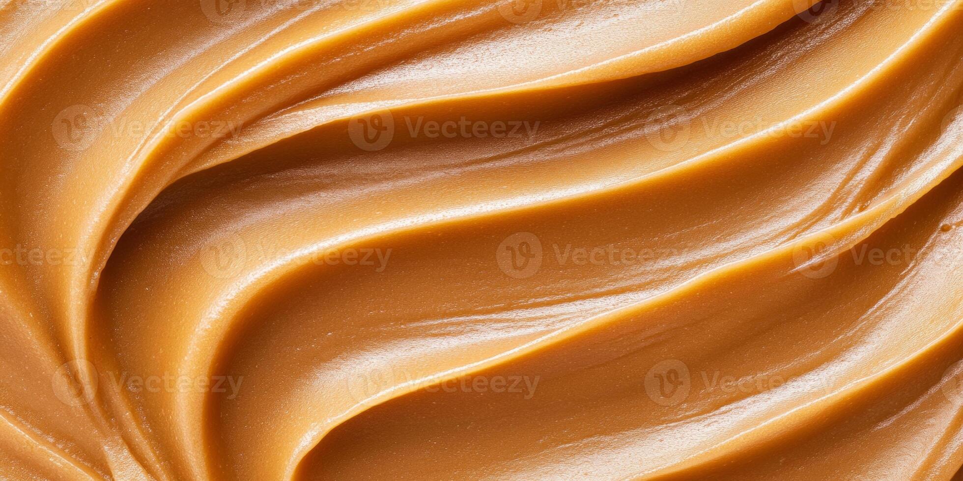 Luxurious caramel flowing smoothly with rich textures and warm tones in soft lighting photo