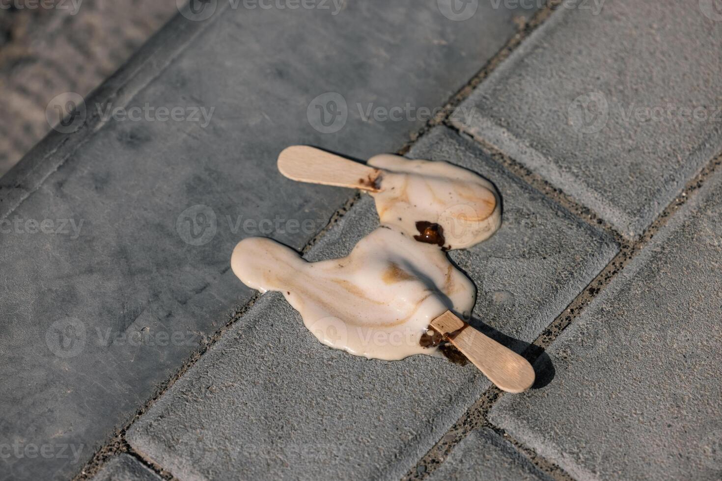 Icecream on the ground. selective focus, chocolate icecream cone photo