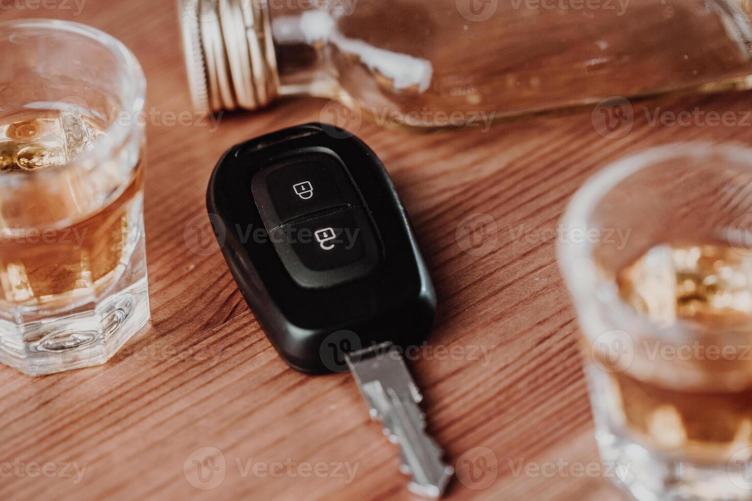 Close up of a car keys and very strong alcohol rum on the table, do not drink and drive concept, driving a car, transportation concept photo