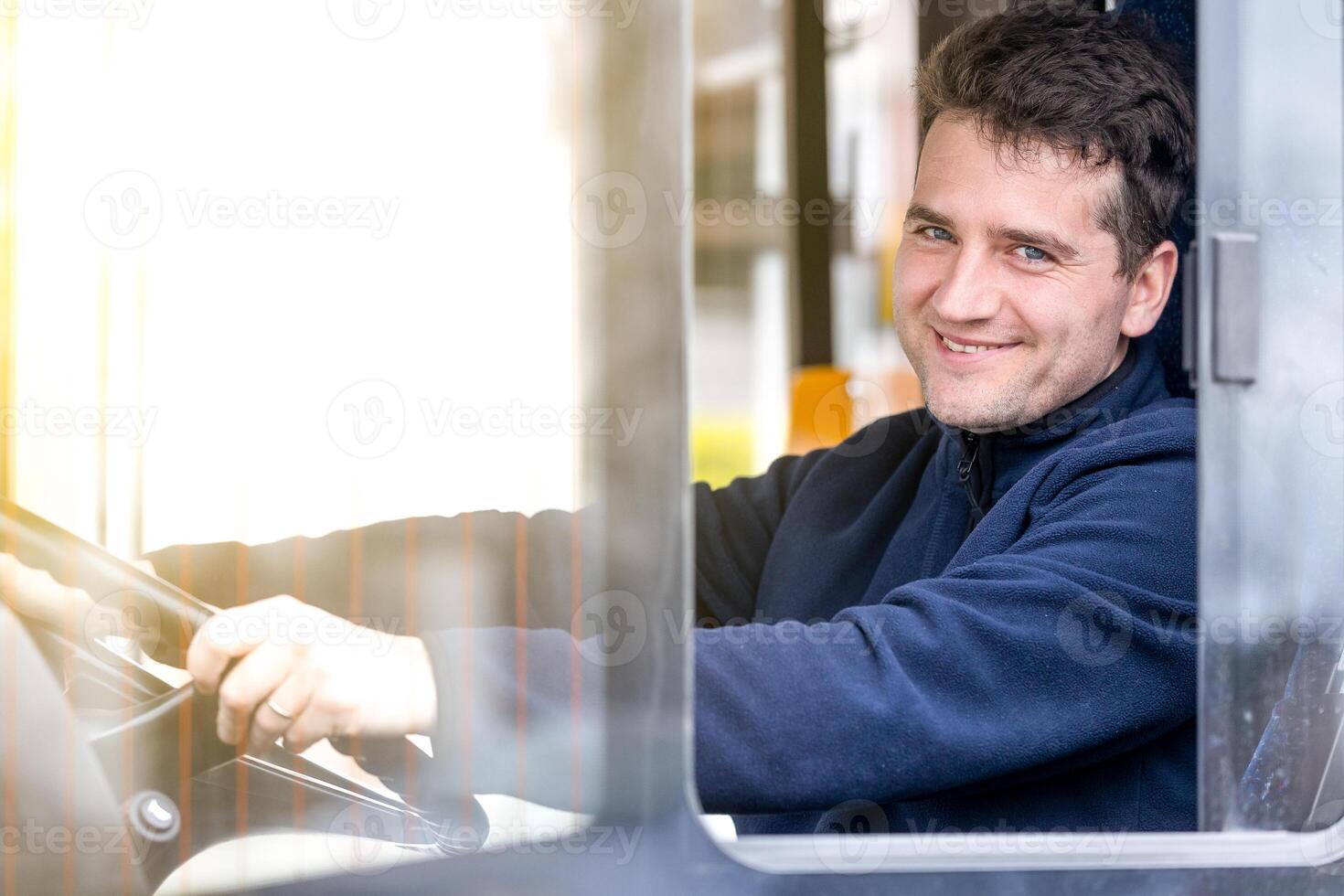 Portrait of handsome bus driver of public transport, concept of urban public transport photo