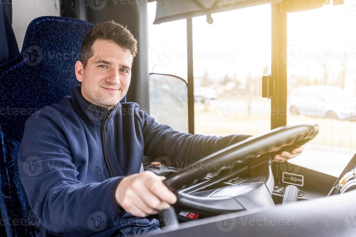 Portrait of handsome bus driver of public transport, concept of urban public transport photo