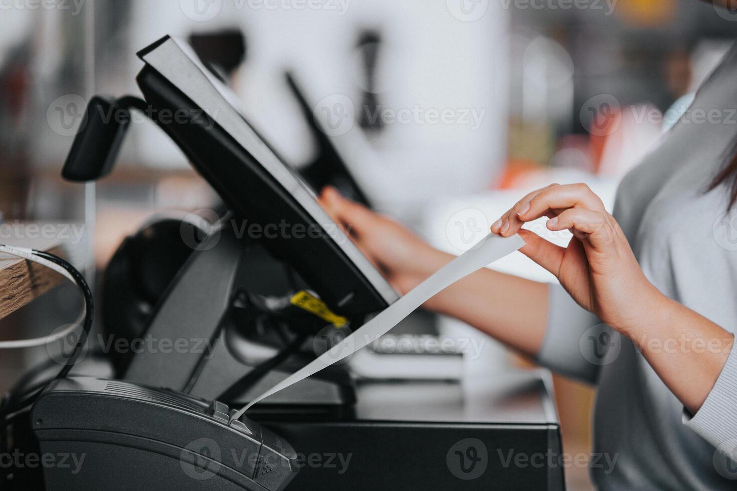 Saleswoman printing invoice or receipt for a customer in the shopping center, POS system, finance concept photo