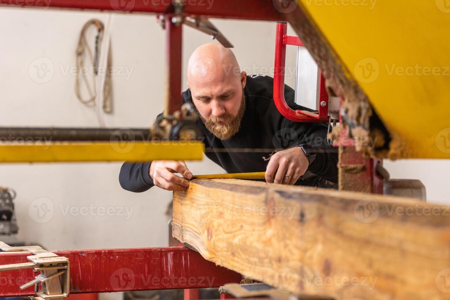 Professional carpenter cutting huge wood to small pieces, joinery concept photo