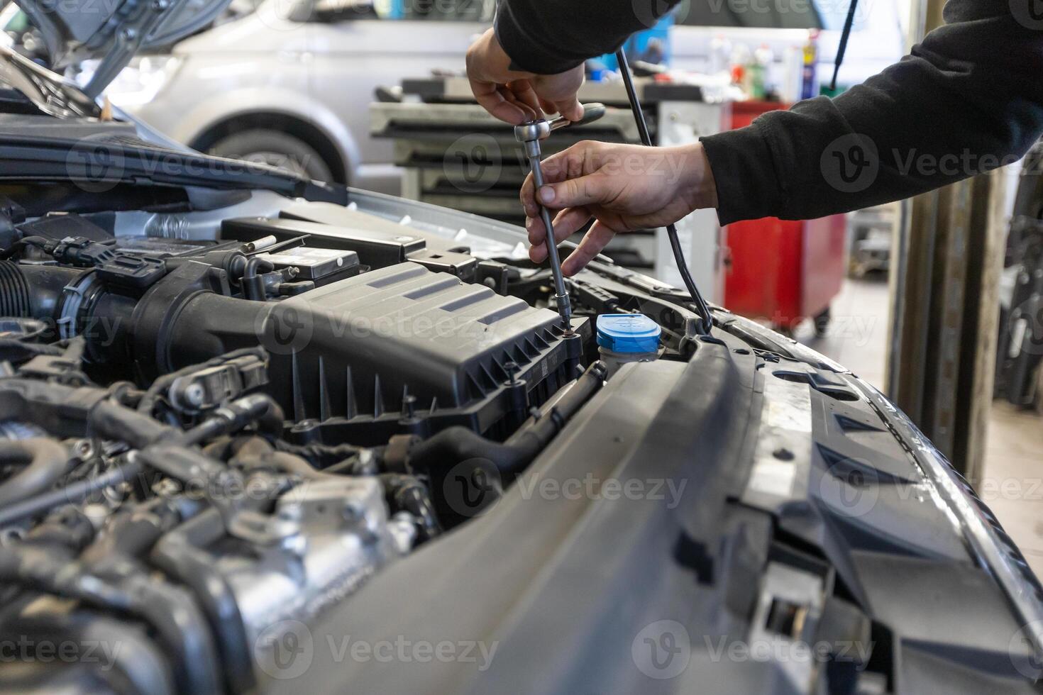 Professional car servis man changing the air filter by the car engine, car service concept photo
