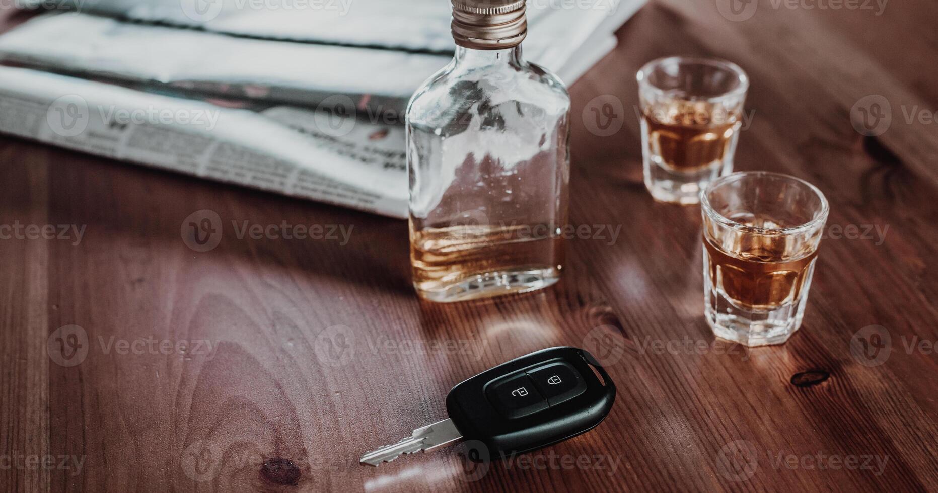 Do not drink and drive concept, Close up of car keys and glass of strong an alcohol rum, driving concept, beware of alcohol photo