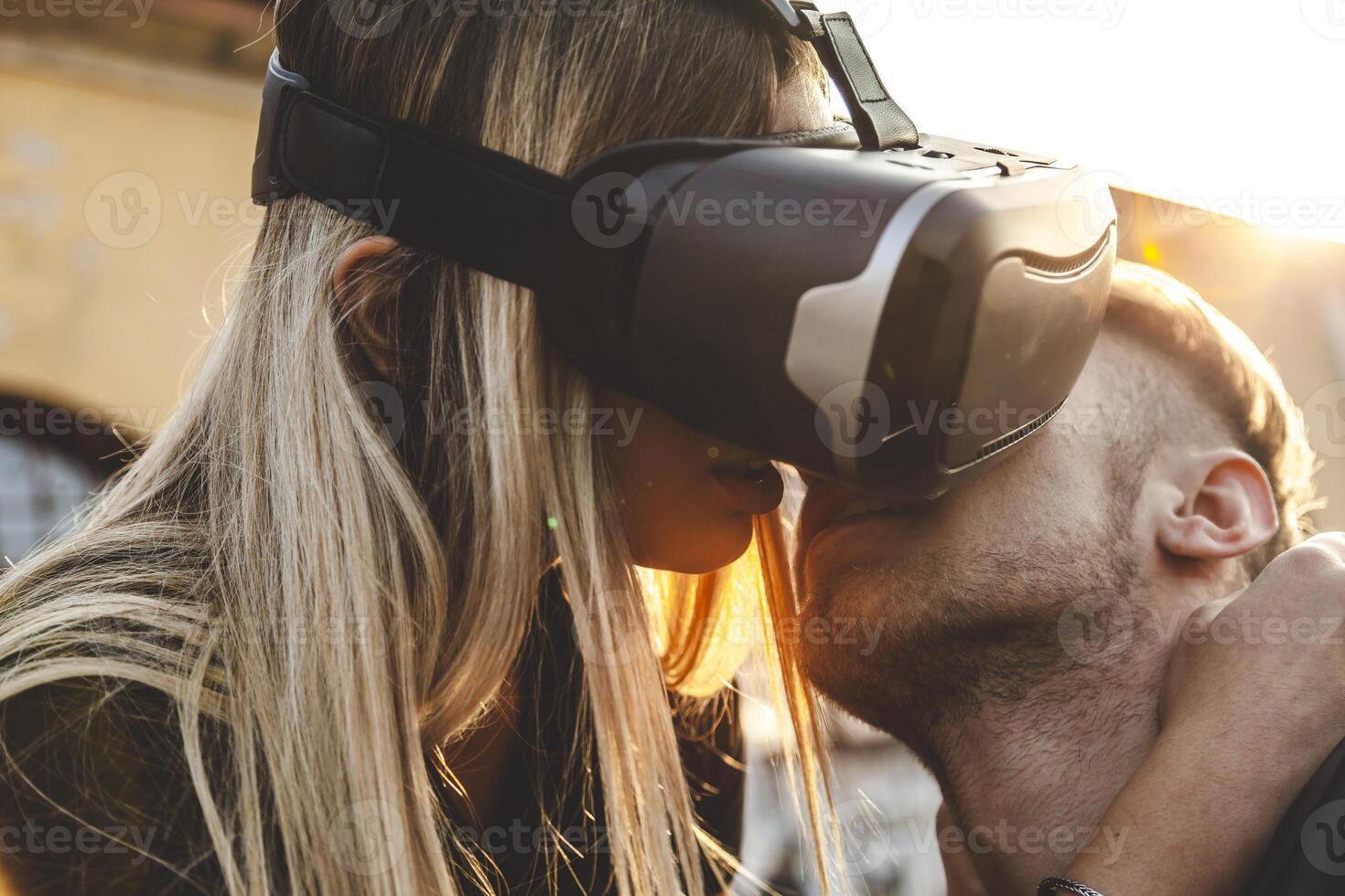 beautiful couple in love hugging with glasses of virtual reality photo