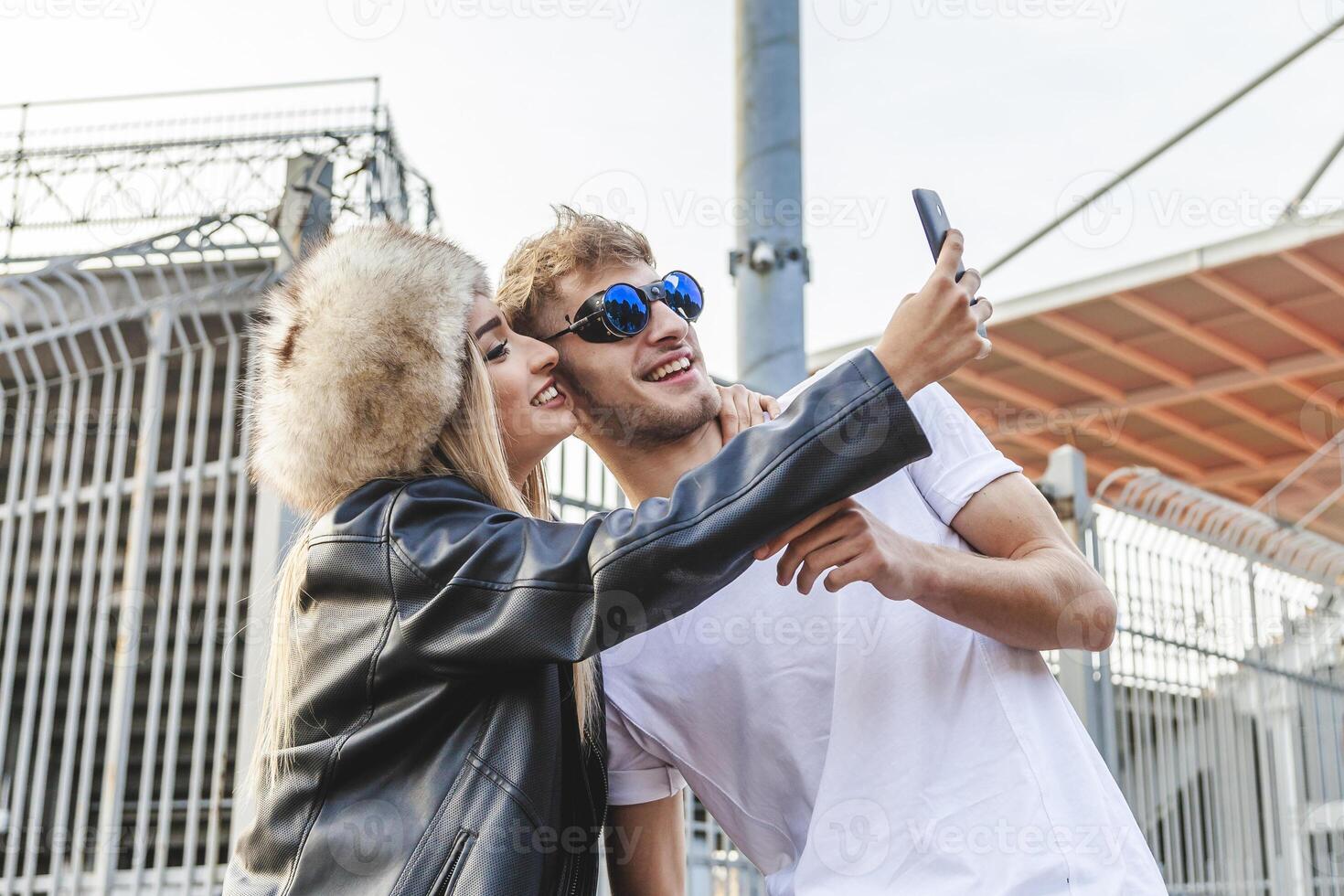 couple of young beautiful lovers take a selfie on the large square photo