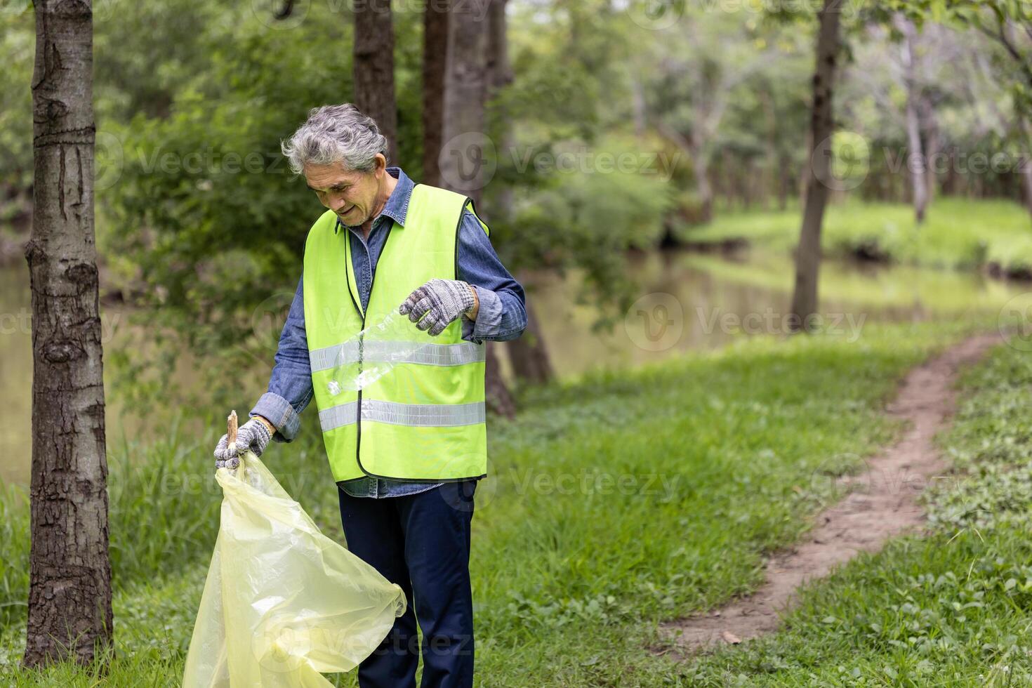 Senior volunteer worker group enjoy charitable social work outdoor in cleaning up garbage and waste separation project at the park or natural forest for community service and recycle concept photo