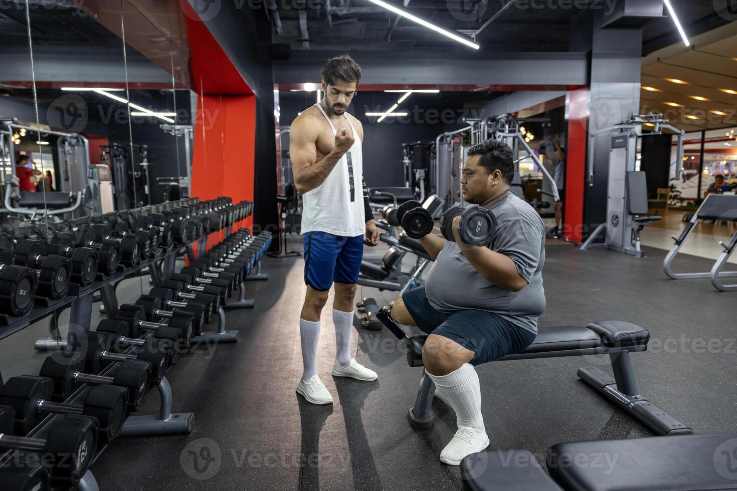 Asian man with prosthetic leg from amputation from diabetes doing weight training workout exercise dumbbells at gym with professional trainer for handicap and disability people and recovery concept photo