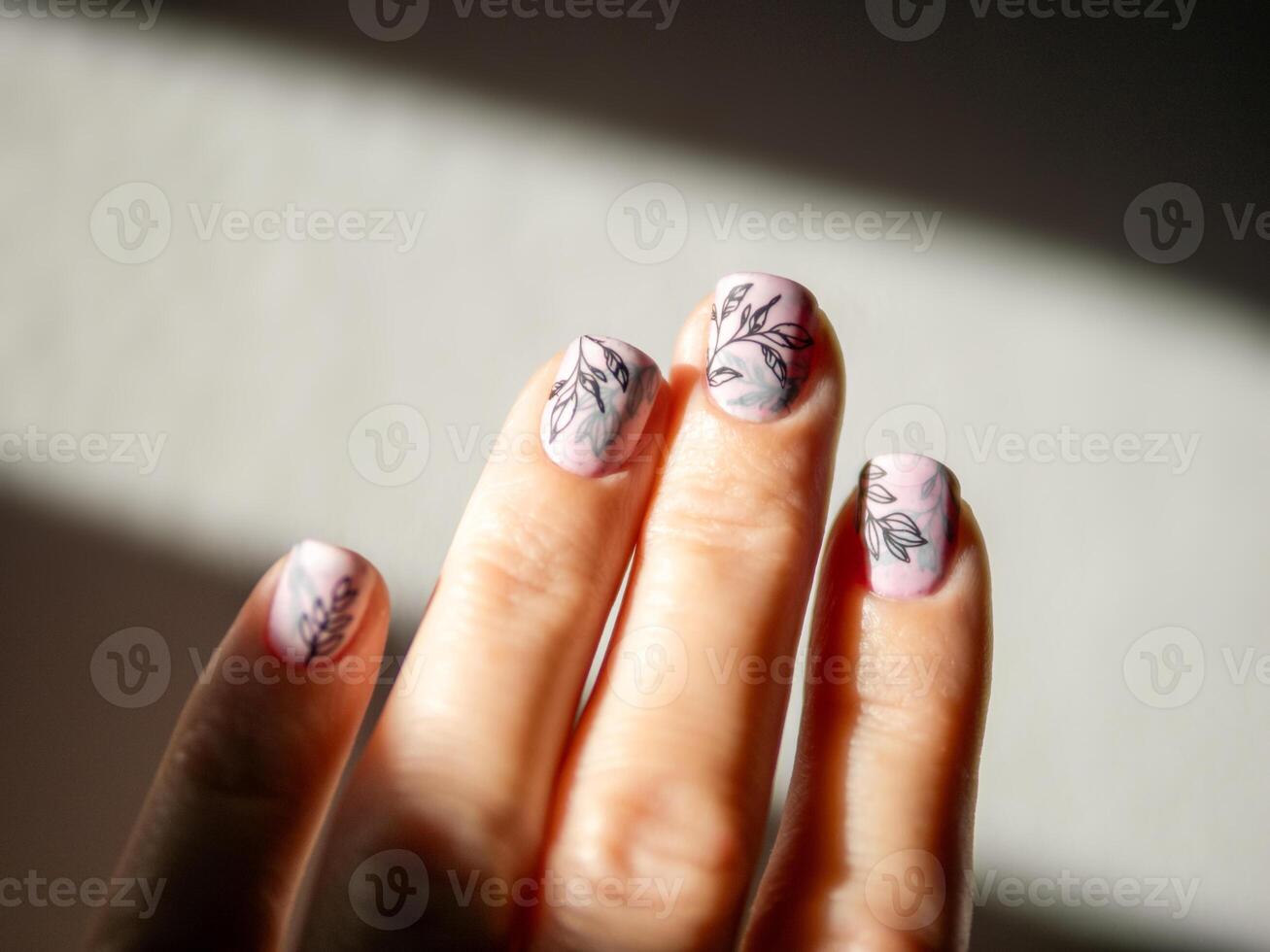 Female Hands With Light Pink Milky Aura Nails Manicure. Woman Fingernails With Pink Nails In Hard Sunlight Background. Floral Botanical Stamping. Aesthetic Visual Of Trendy Manicure With Nail Art. photo