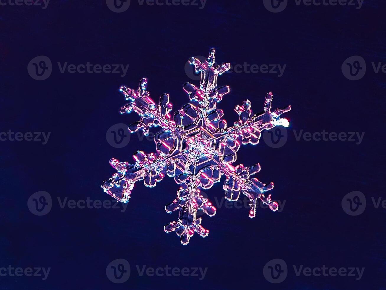 Super macro photography of snowflake. Snowflake natural crystal single isolated on dark blue background, transparent abstract photo background