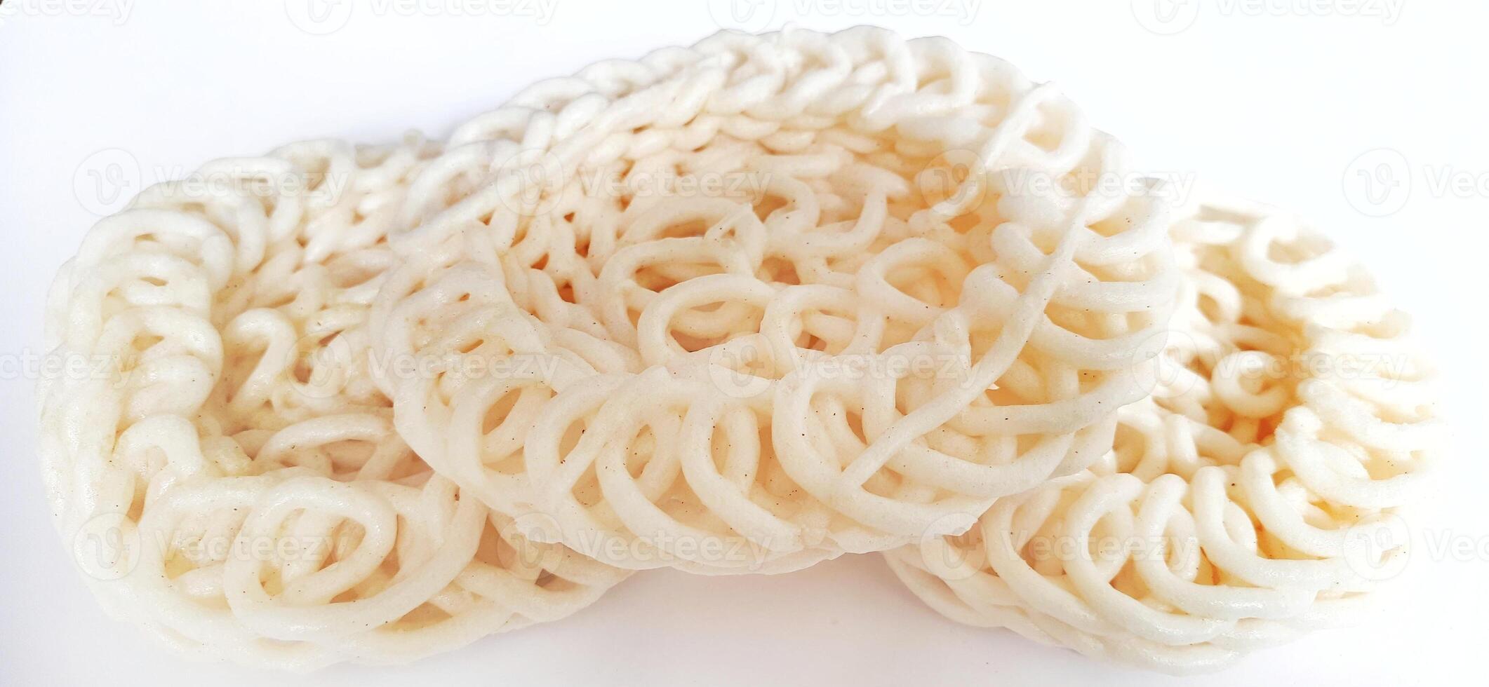 White noodle crackers or kerupuk putih or kerupuk warung made from tapioca flour, snack food from Indonesia isolated on white background photo
