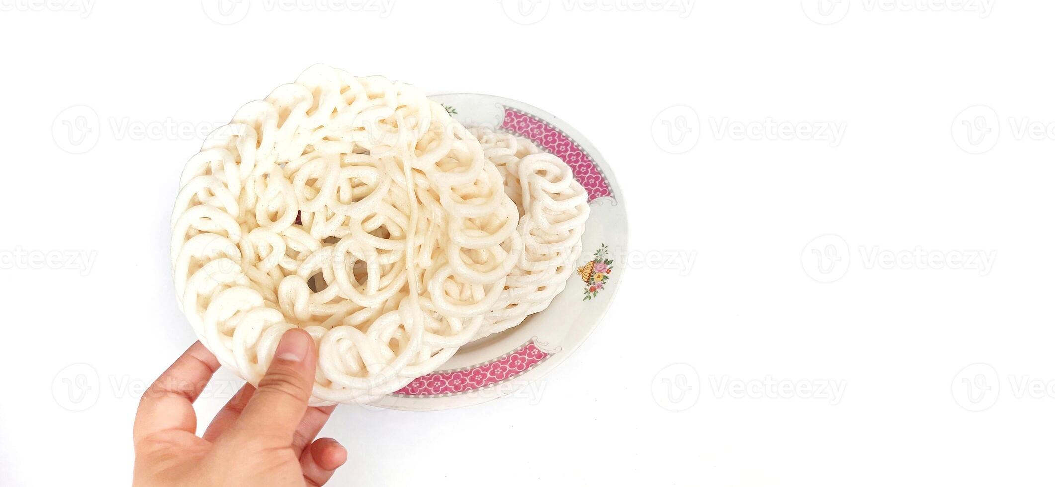 White noodle crackers or kerupuk putih or kerupuk warung made from tapioca flour, snack food from Indonesia isolated on white background photo
