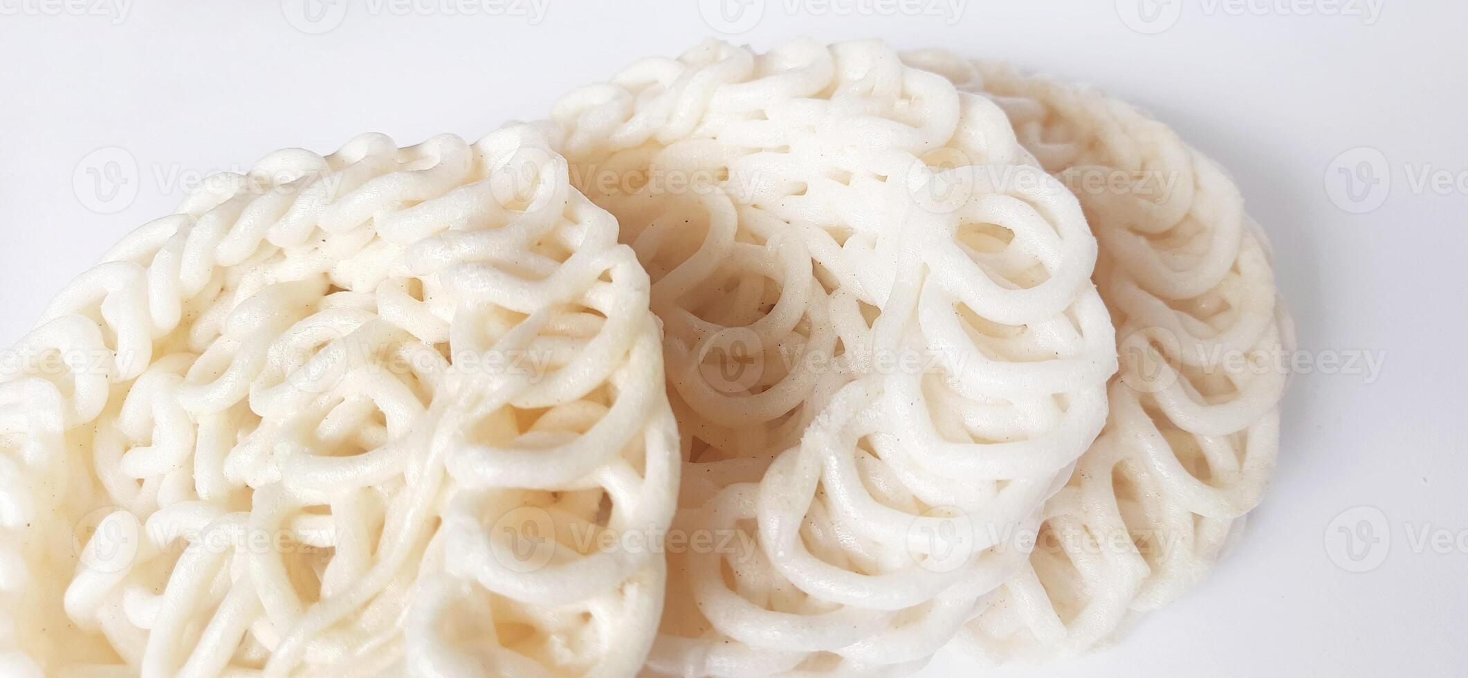 White noodle crackers or kerupuk putih or kerupuk warung made from tapioca flour, snack food from Indonesia isolated on white background photo