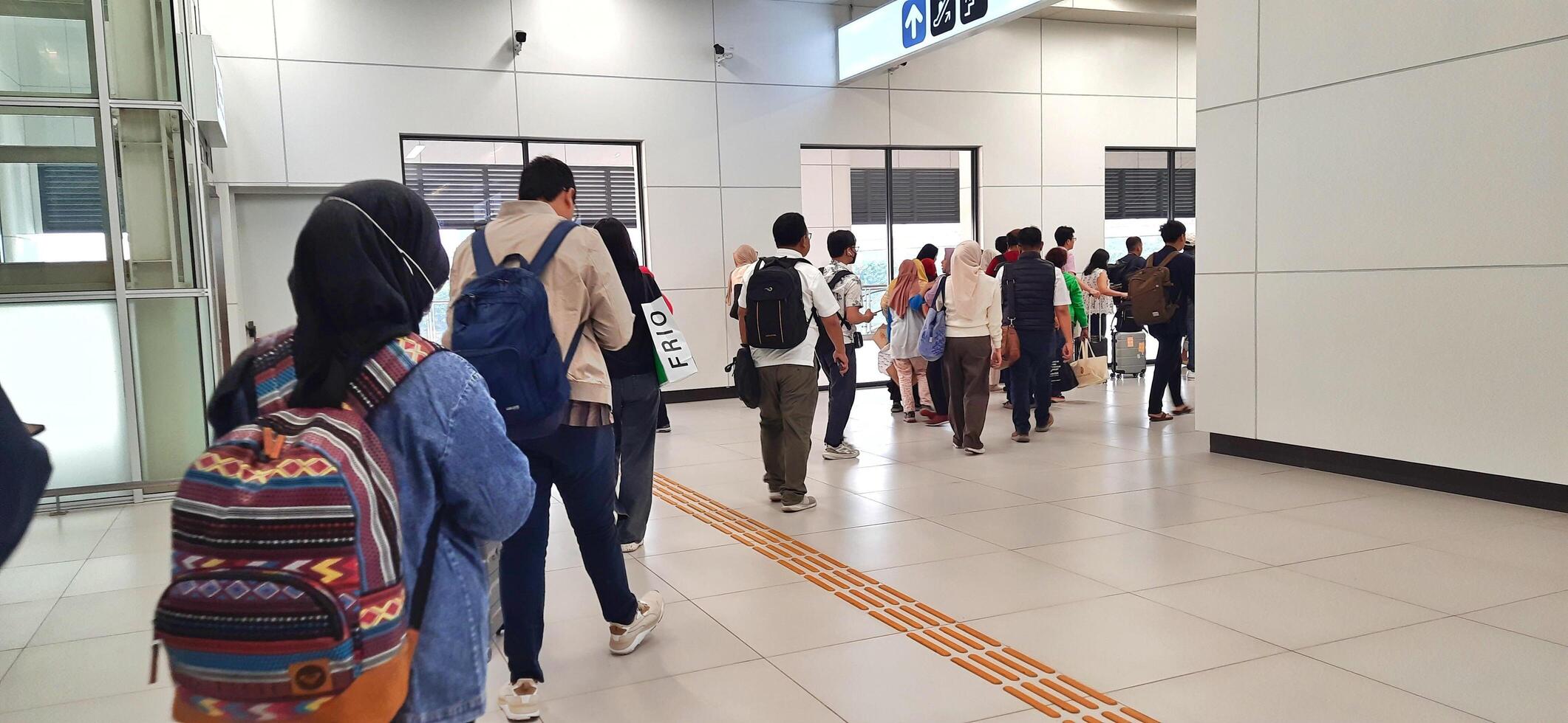 The atmosphere of KCIC Halim station, WHOOSH fast train, route Jakarta - Bandung. Modern passenger train moving fast on railway platform. Commercial transportation. Jakarta, Indonesia, October 28 2024 photo