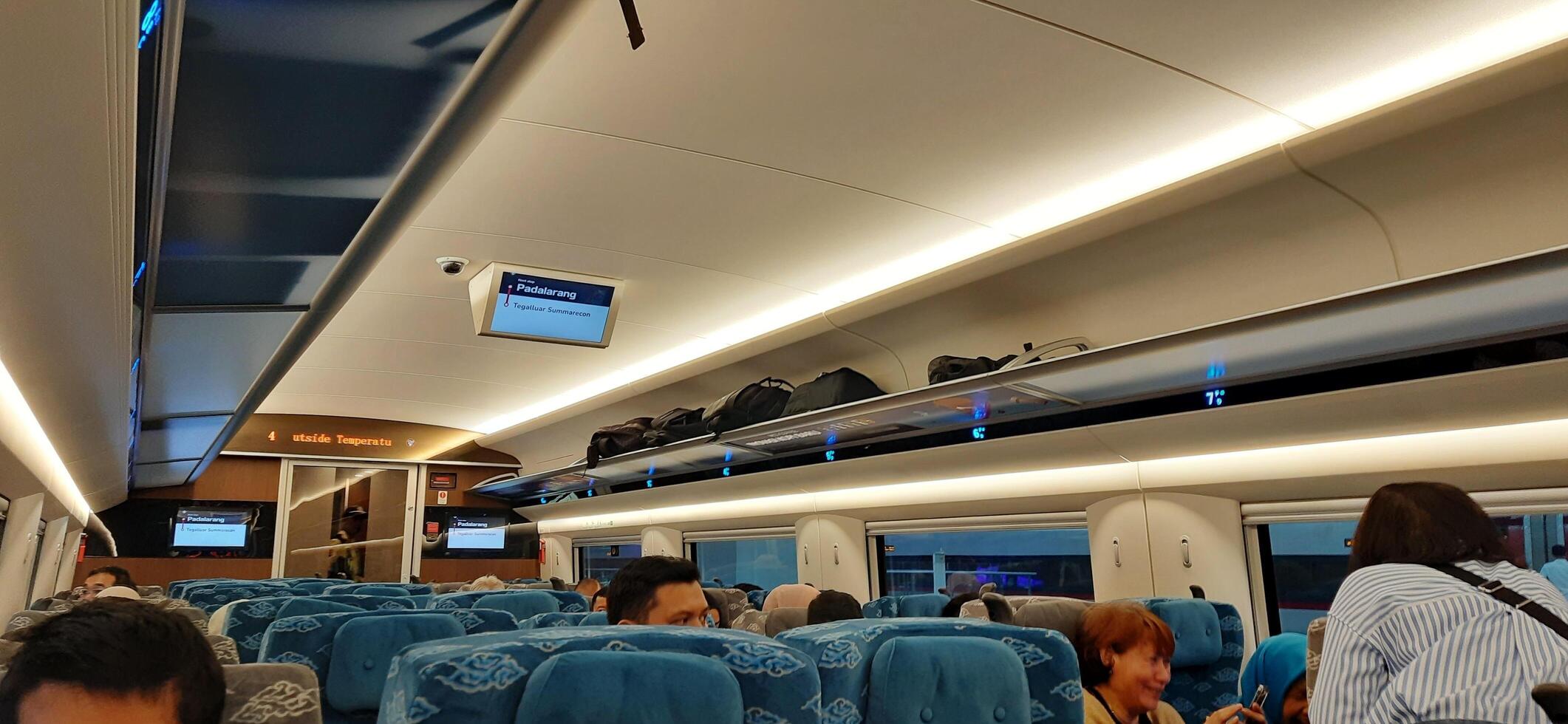 Inside on fast train WHOOSH, KCIC Halim station. Modern passenger train moving fast on railway platform. Commercial transportation. Jakarta, Indonesia, October 28 2024 photo