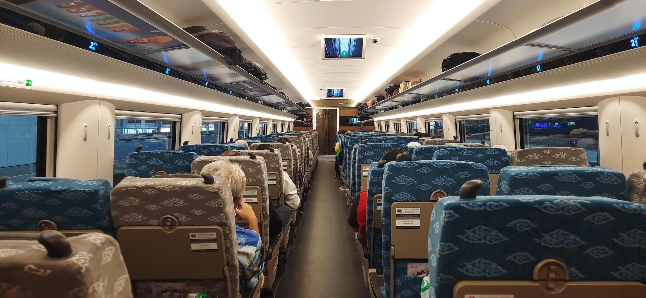 Inside on fast train WHOOSH, KCIC Halim station. Modern passenger train moving fast on railway platform. Commercial transportation. Jakarta, Indonesia, October 28 2024 photo