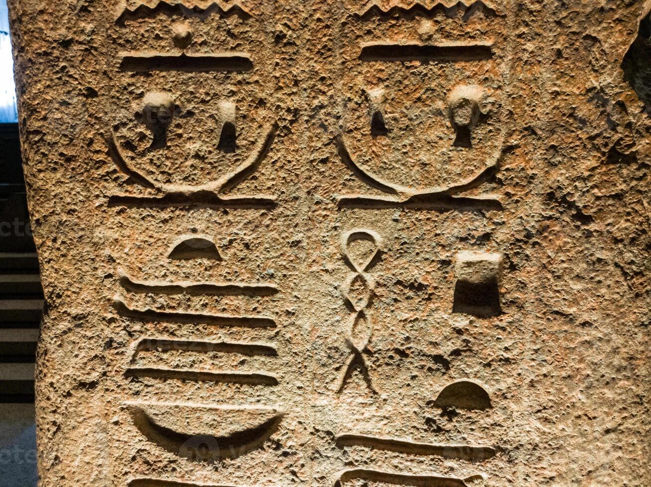 Old Egyptian hieroglyphs on an stone background. Ancient Egyptian hieroglyphs as pattern in Tombs. photo