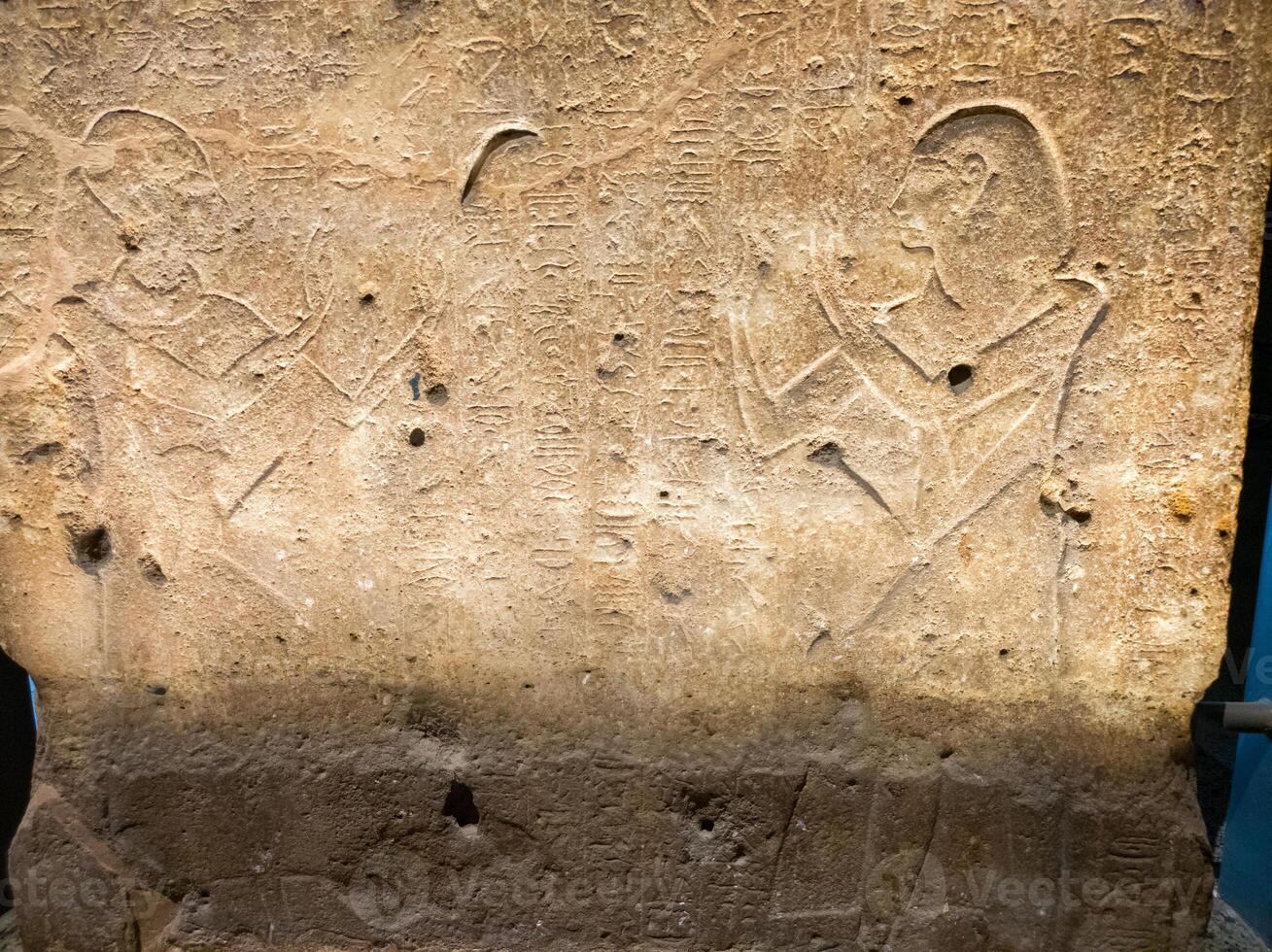 Old Egyptian hieroglyphs on an stone background. Ancient Egyptian hieroglyphs as pattern in Tombs. photo