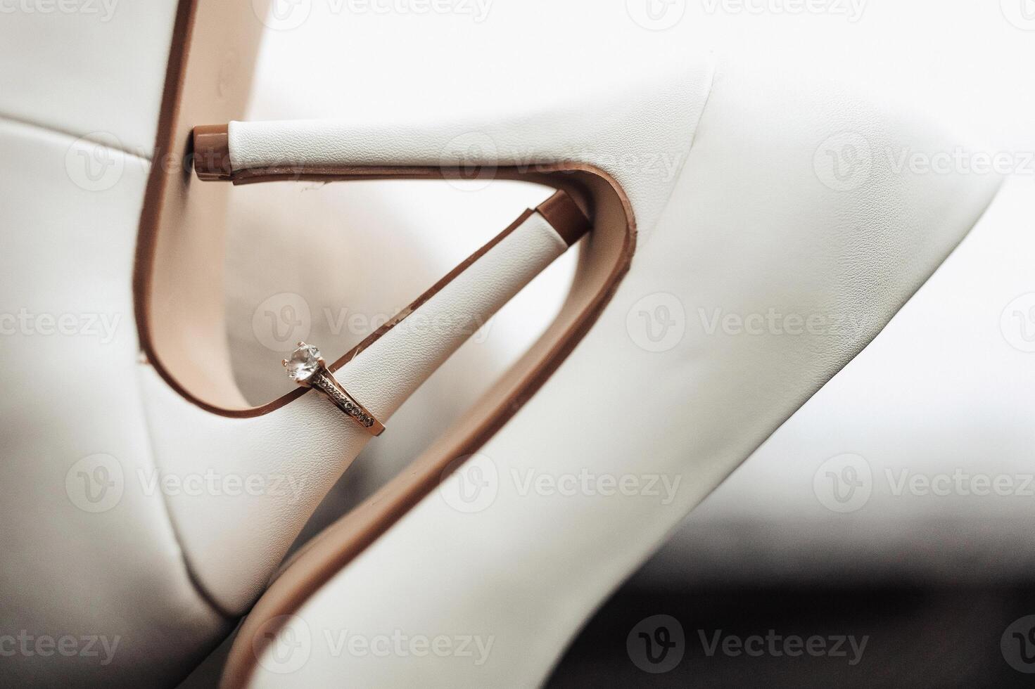 A close up of a woman's shoe with a ring on the toe photo