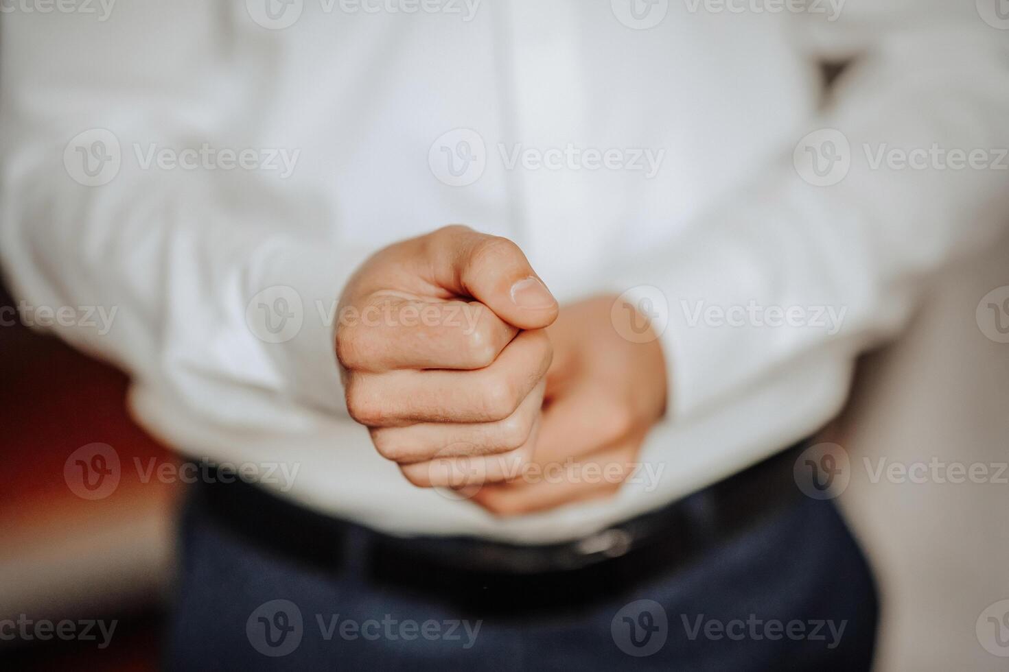 A man is wearing a white shirt and blue pants photo
