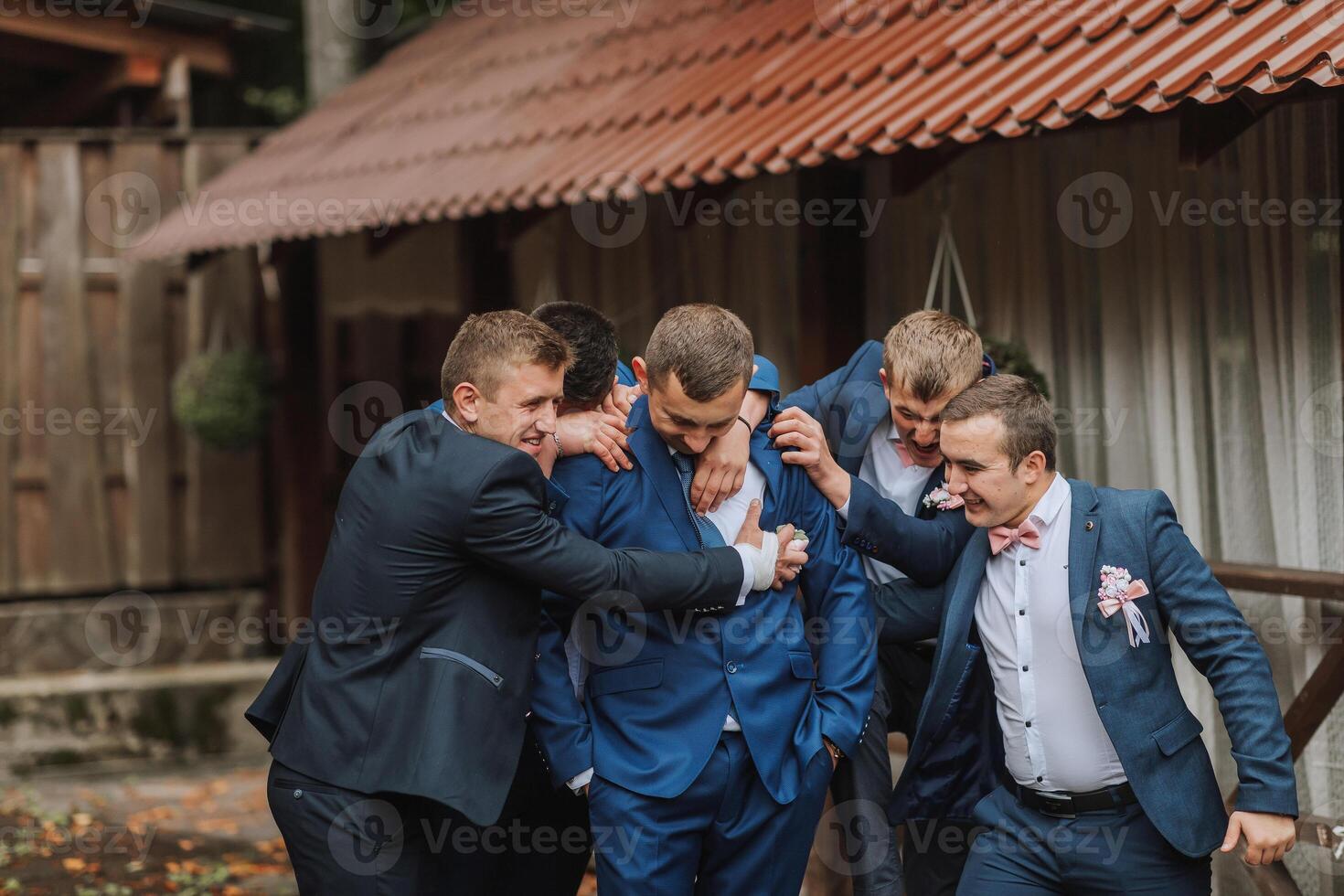 A group of men in suits are hugging each other photo