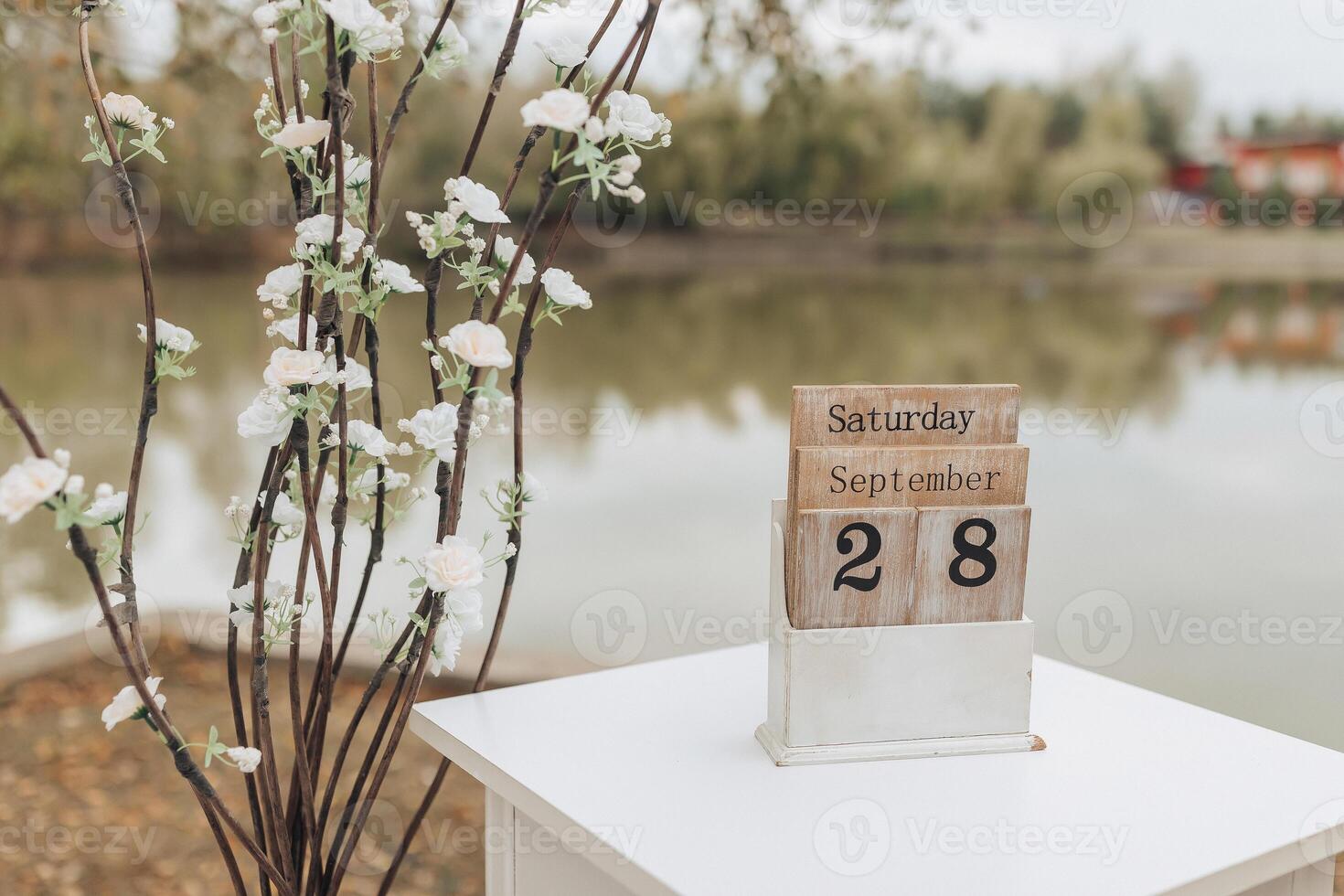 A white table with a wooden calendar on it photo