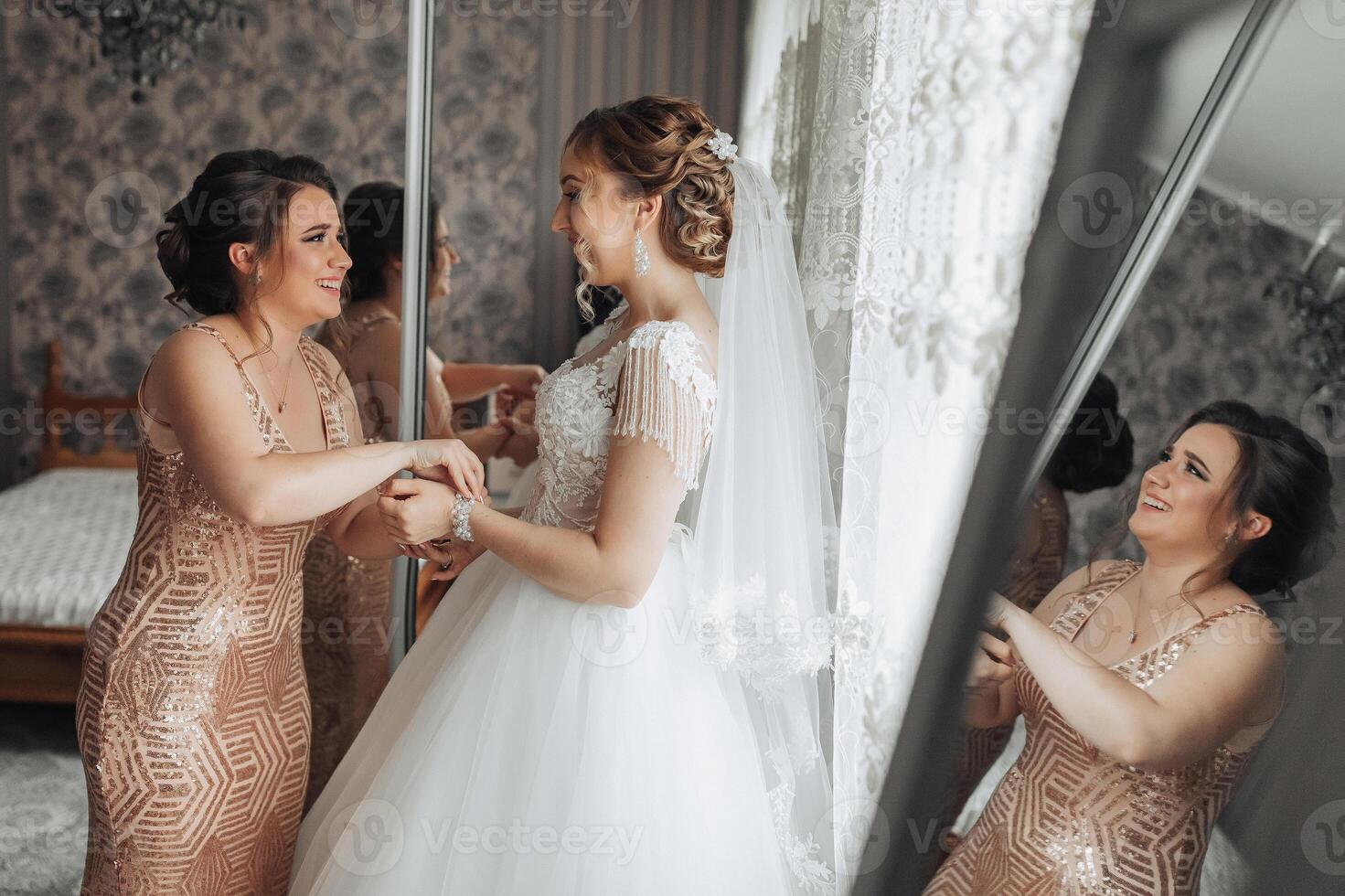 A bride and her bridesmaid are getting ready for the wedding photo