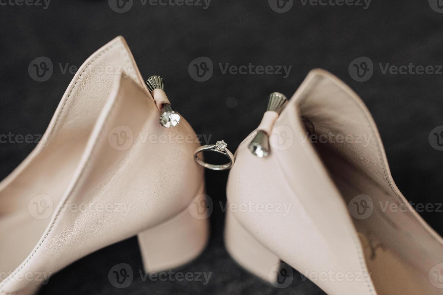 Two shoes with a ring on the toe photo
