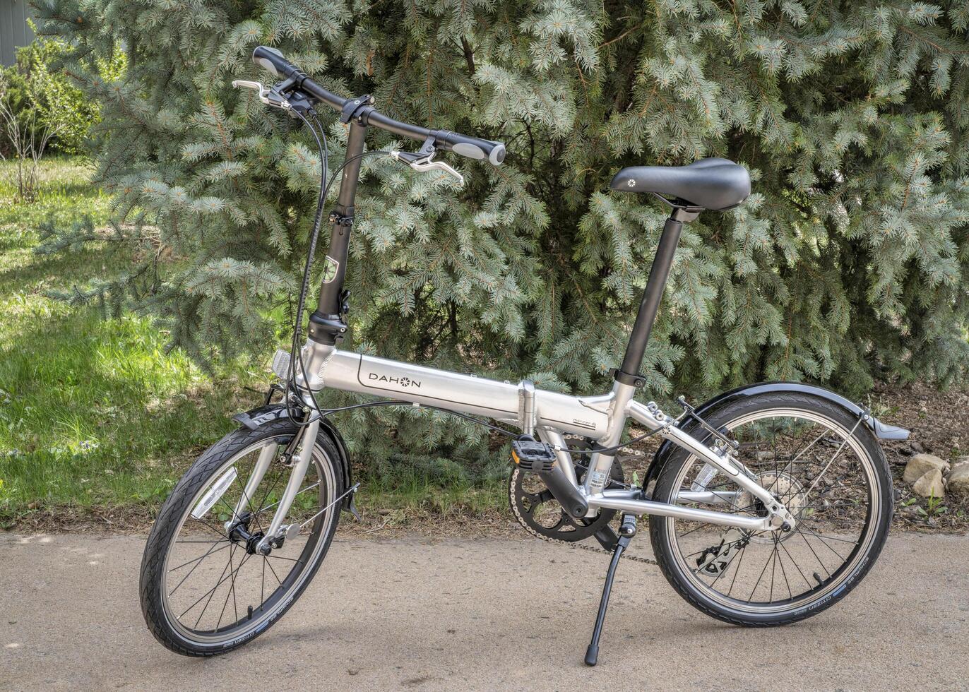 Fort Collins, CO, USA - May 4, 2023, A popular, lightweight, folding bike, Dahon Mariner D8, in a driveway ready for city commuting. photo