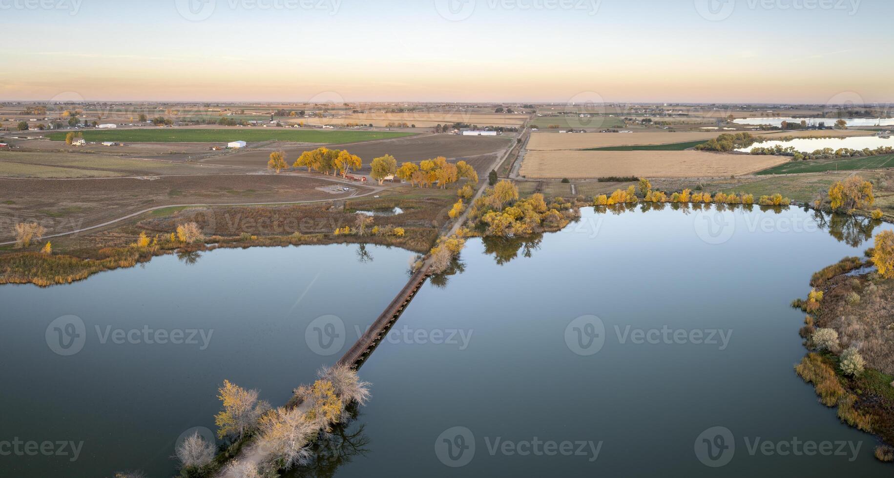long footbridge over Roulard Lake near Severance, Colorado in fall scenery - Great Western Bike Trail, rails to trails conversion project photo