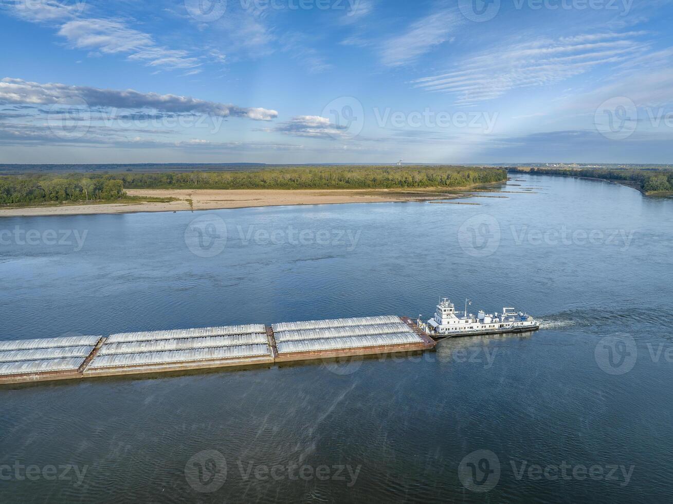 towboat with barges on the Mississippi River at confluence with the Missouri River below Alton, IL photo