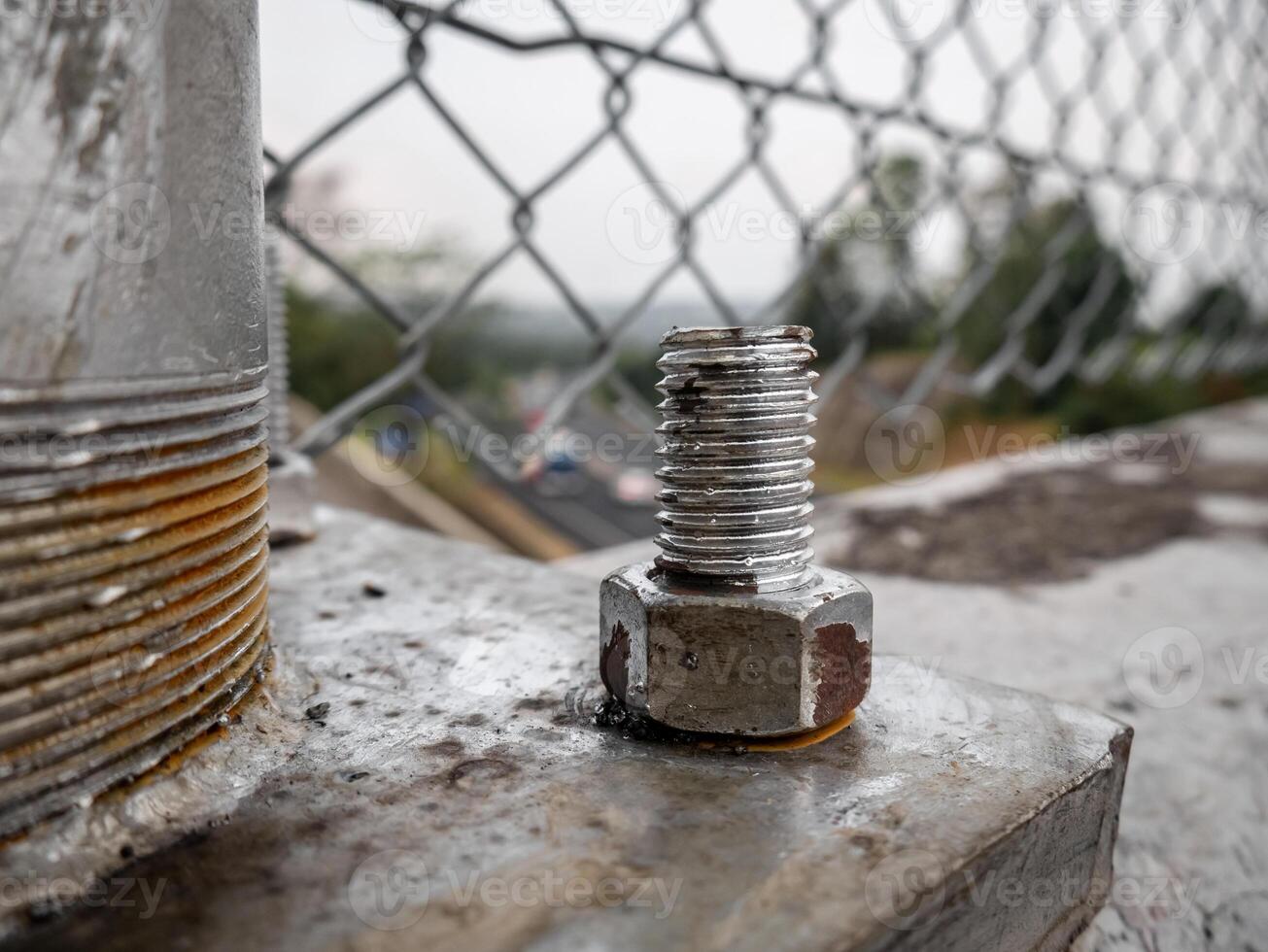 bolts attached to iron poles and painted silver photo