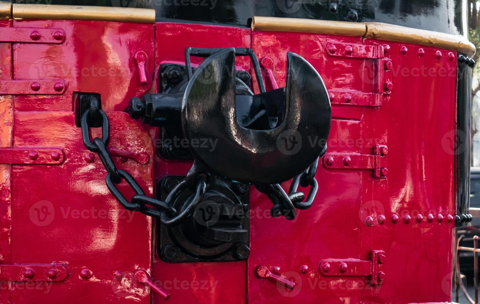 A coupler on an old locomotive that is well maintained and displayed at the station photo