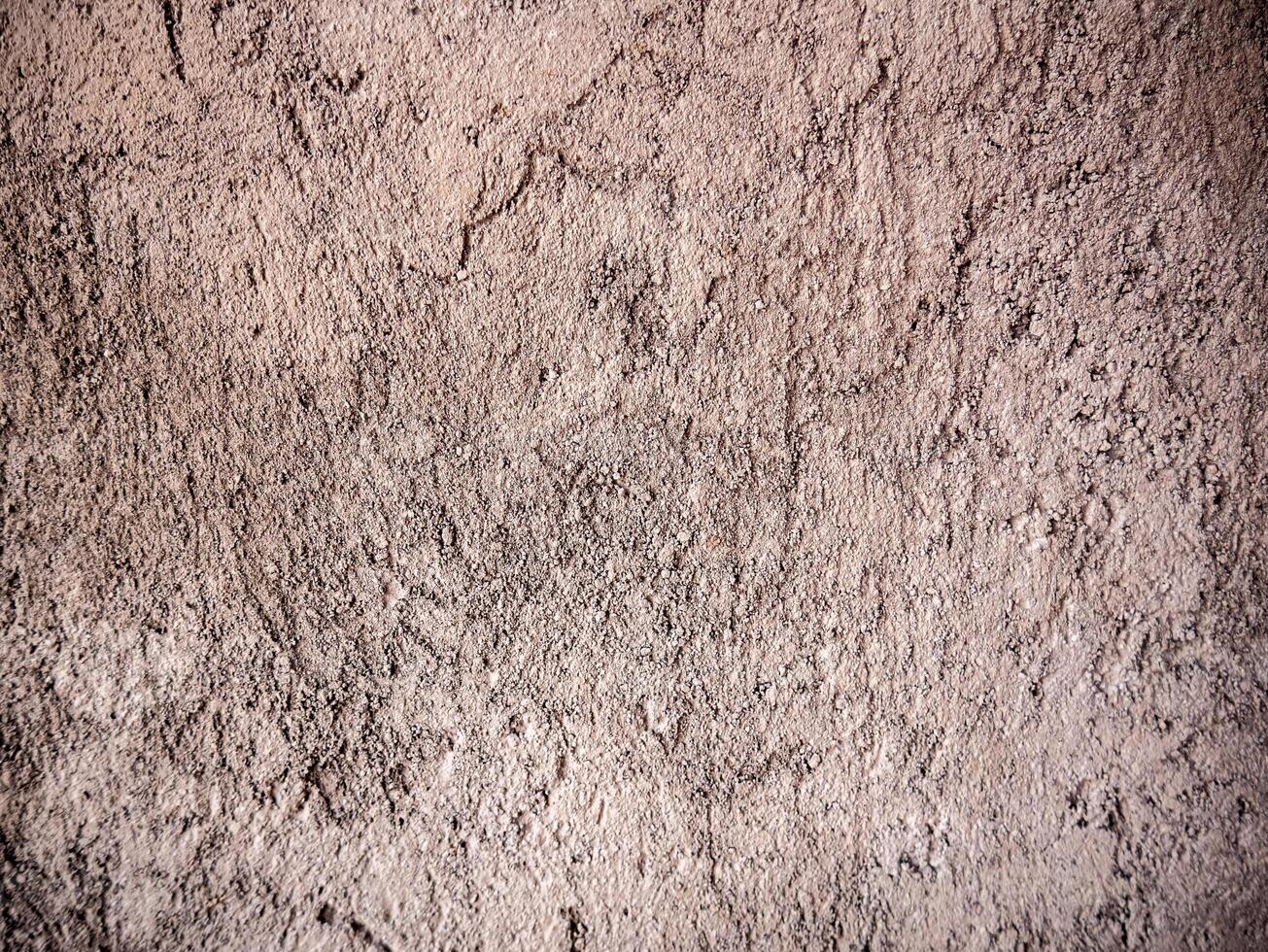 Wall background with rough surface due to unfinished wall plaster photo