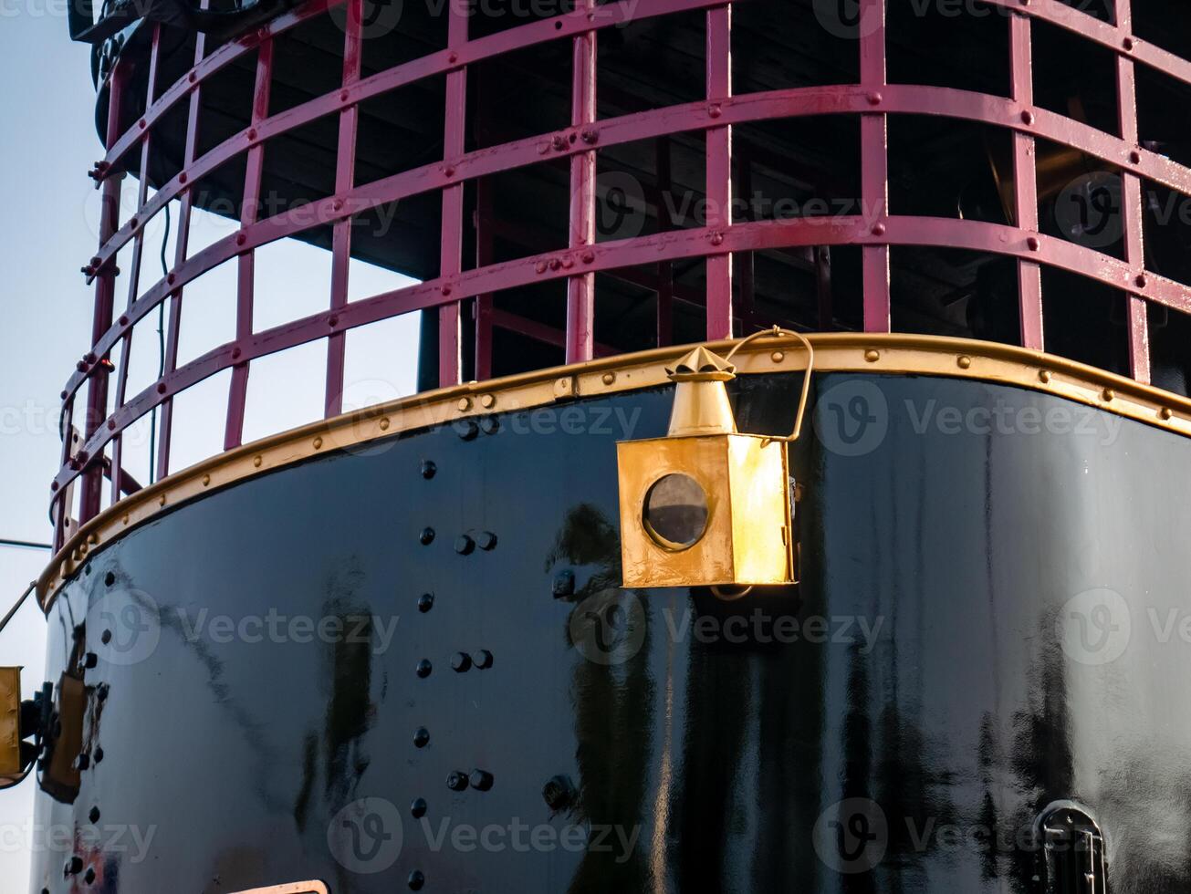 old lamp mounted on the front of an old locomotive displayed at the station photo