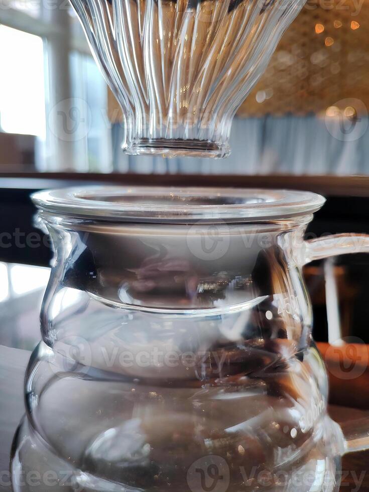 Set of pourover coffee server including heat resistant glass dripper mug, reusable filters or clever dripper, and wooden stand bracket holder, hand drip machine photo