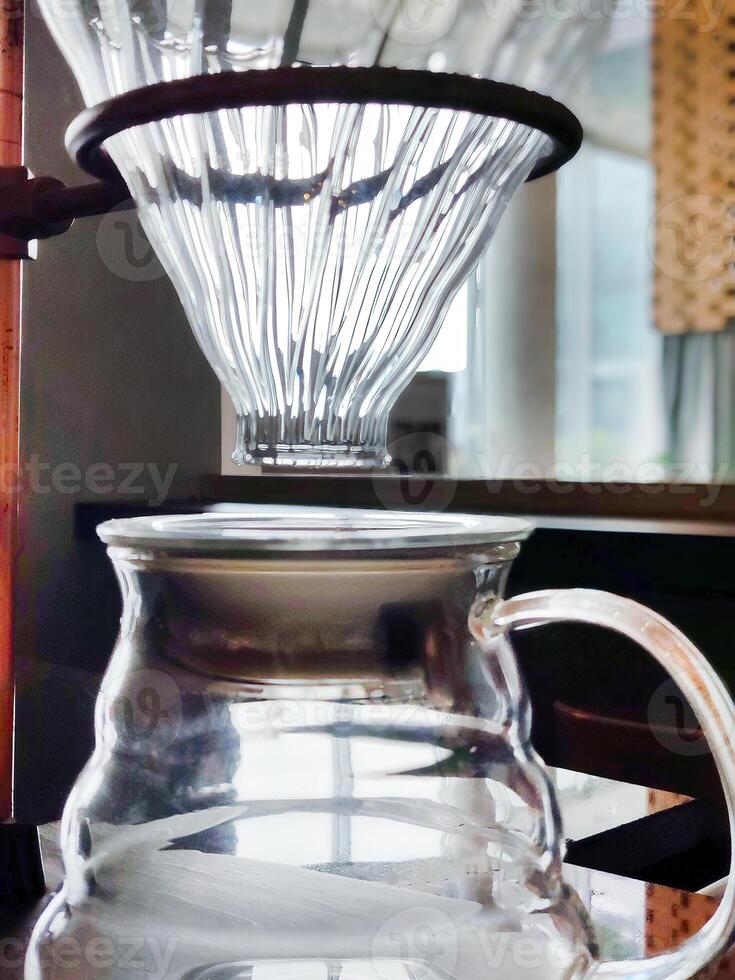 Set of pourover coffee server including heat resistant glass dripper mug, reusable filters or clever dripper, and wooden stand bracket holder, hand drip machine photo
