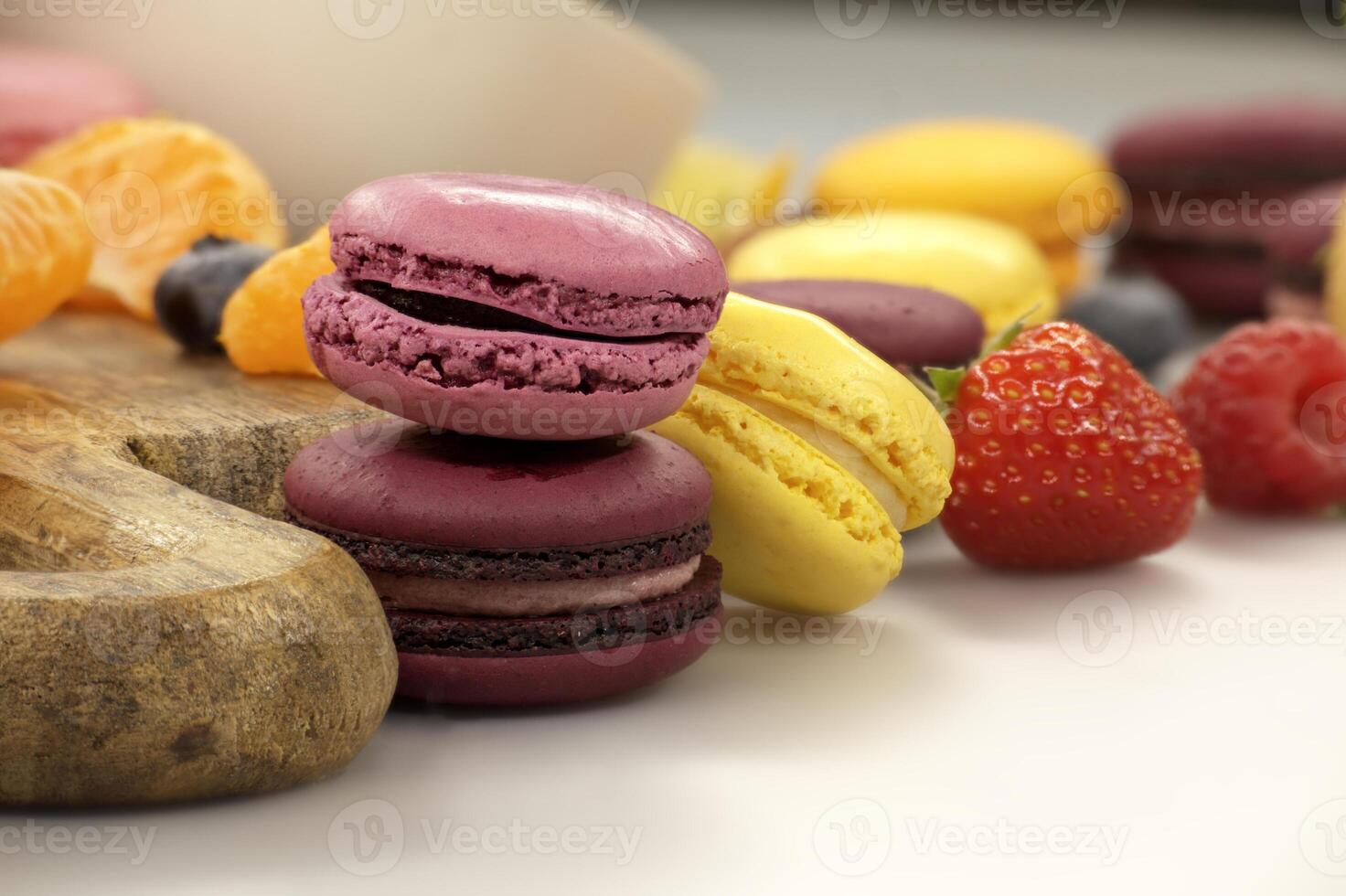 Vibrant scene of table filled with macaroons and fruits photo