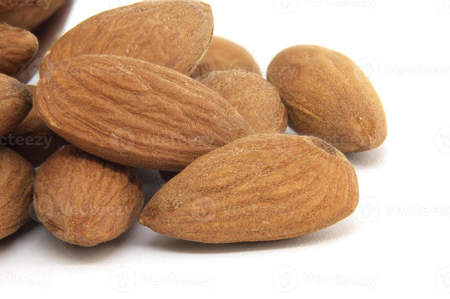 Closeup of raw almonds isolated on a white background photo
