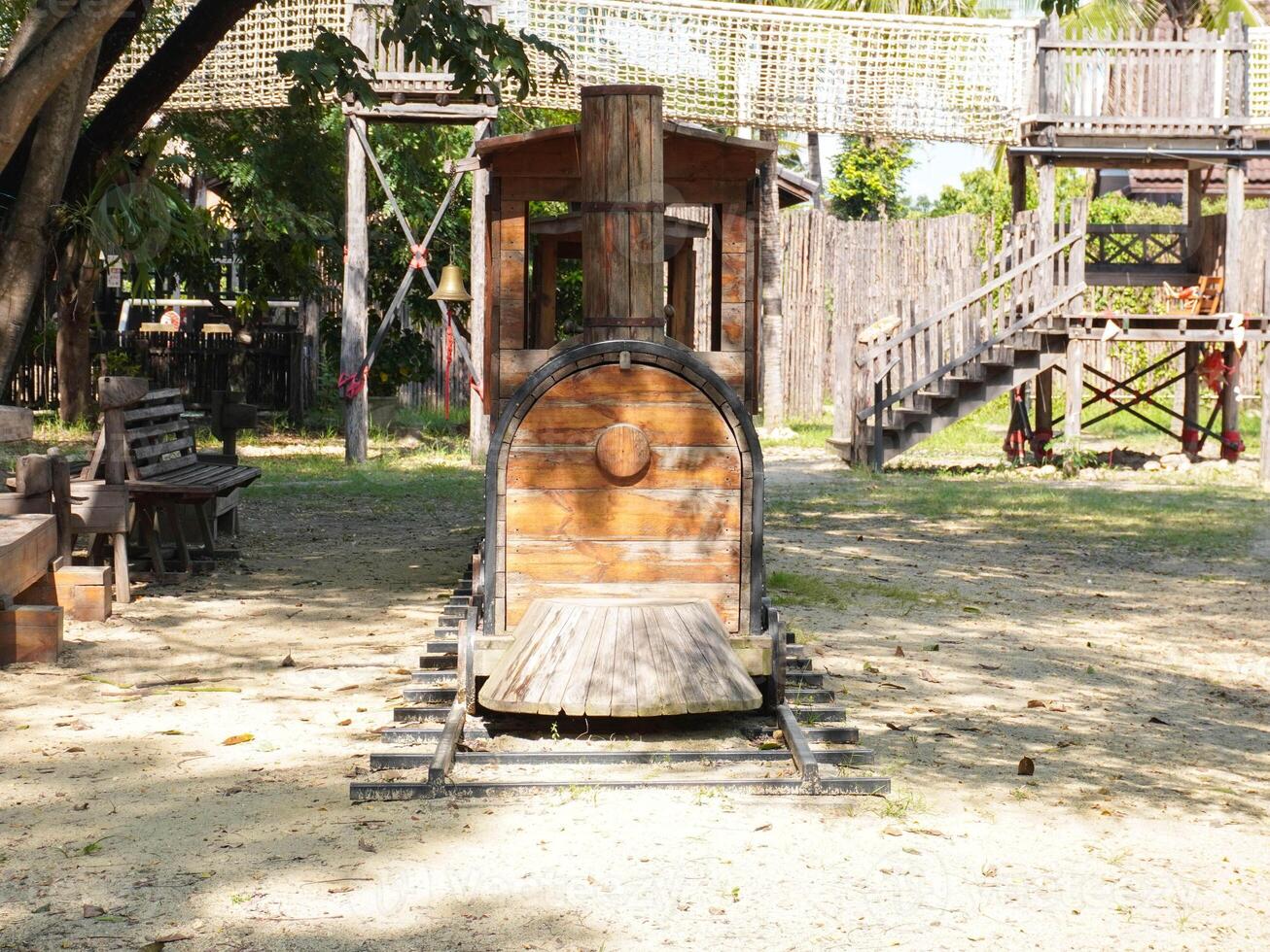 Summer park playground with swings, slides and climbing equipment. Modern wooden playground equipment for children's amusement park. photo