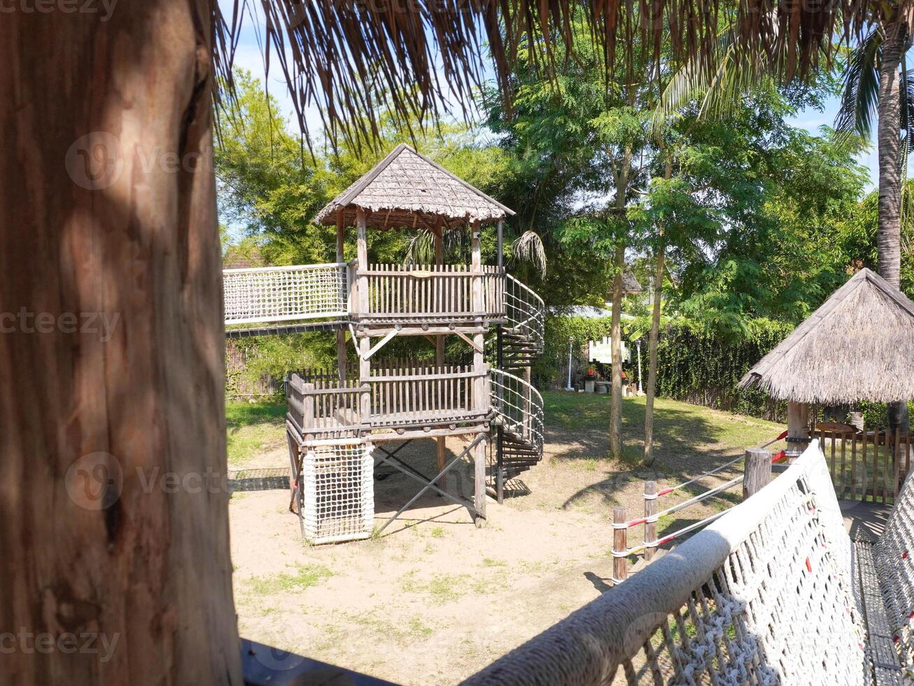 Summer park playground with swings, slides and climbing equipment. Modern wooden playground equipment for children's amusement park. photo