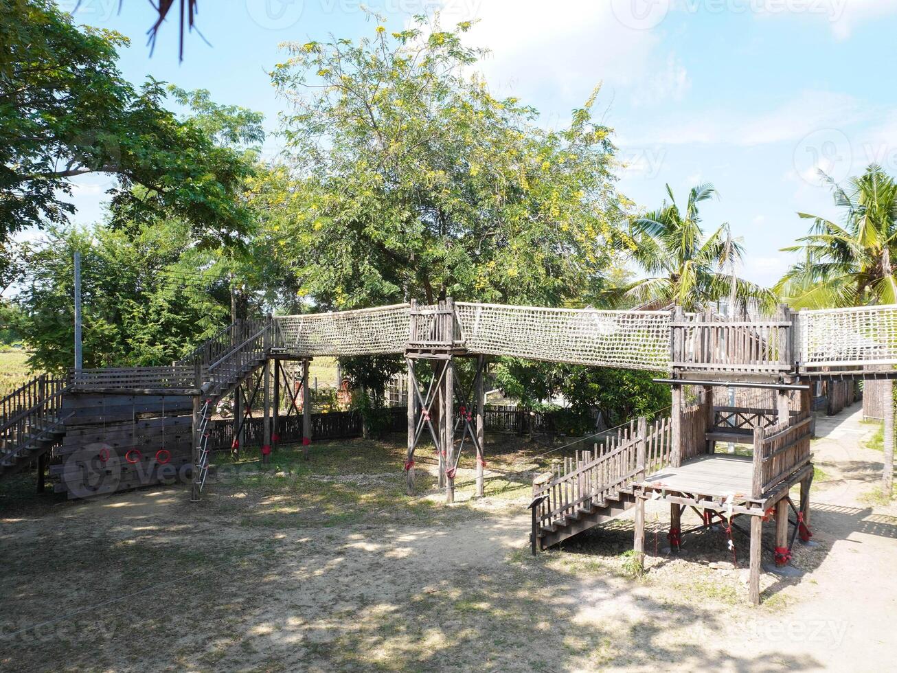 Summer park playground with swings, slides and climbing equipment. Modern wooden playground equipment for children's amusement park. photo